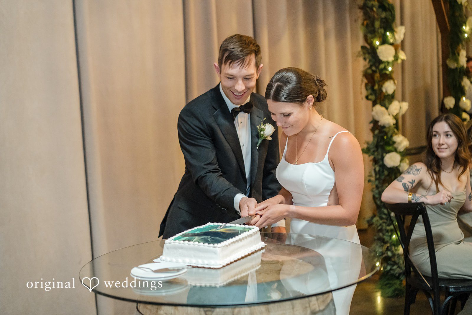 A bride and groom cutting their wedding cake together.