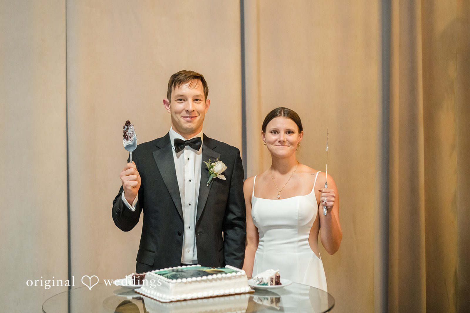 A bride and groom smiling together at their reception.