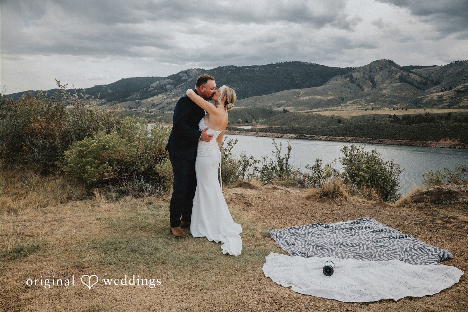 Our Denver wedding photographers at Original Weddings captured the moment the couple shared a kiss in the outdoors of Horsetooth Reservoir Fort Collins