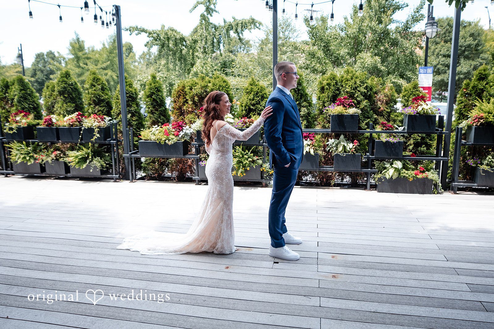 Lucy + Cormac A bride and groom standing next to each other on a pavement.
