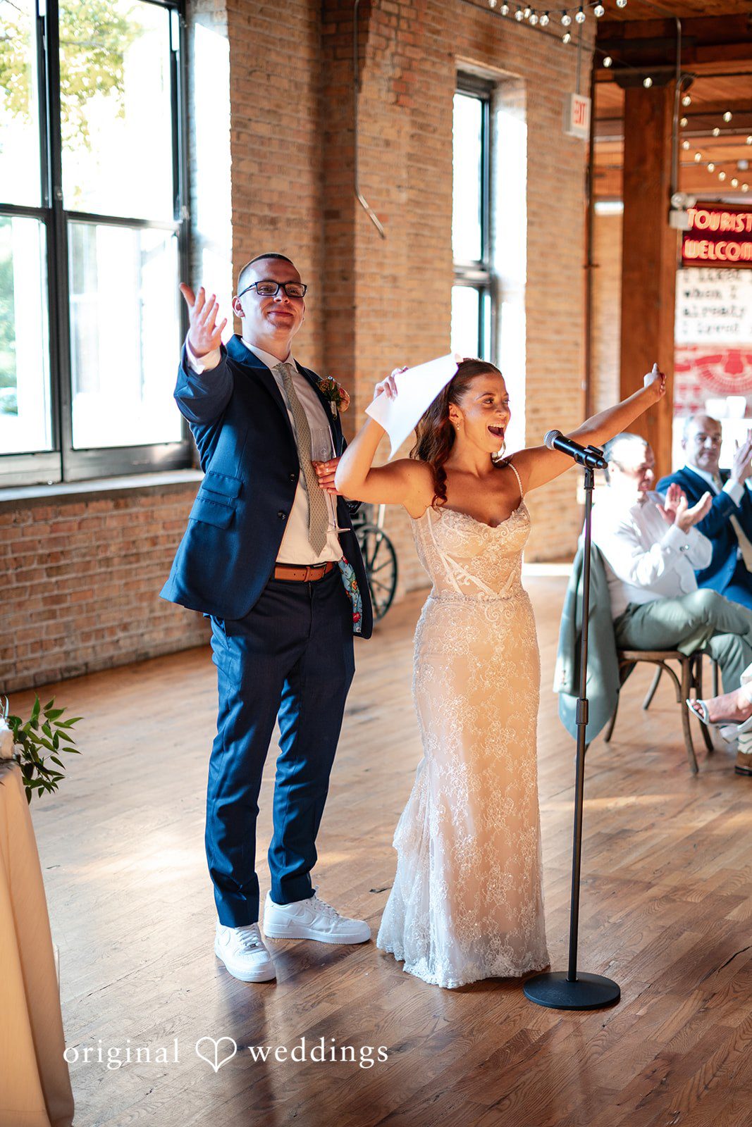 Lucy + Cormac A bride dancing while the groom and guests look on at the reception.