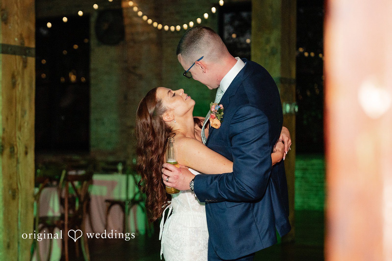 Lucy + Cormac A groom embracing the bride from behind on a dance floor.