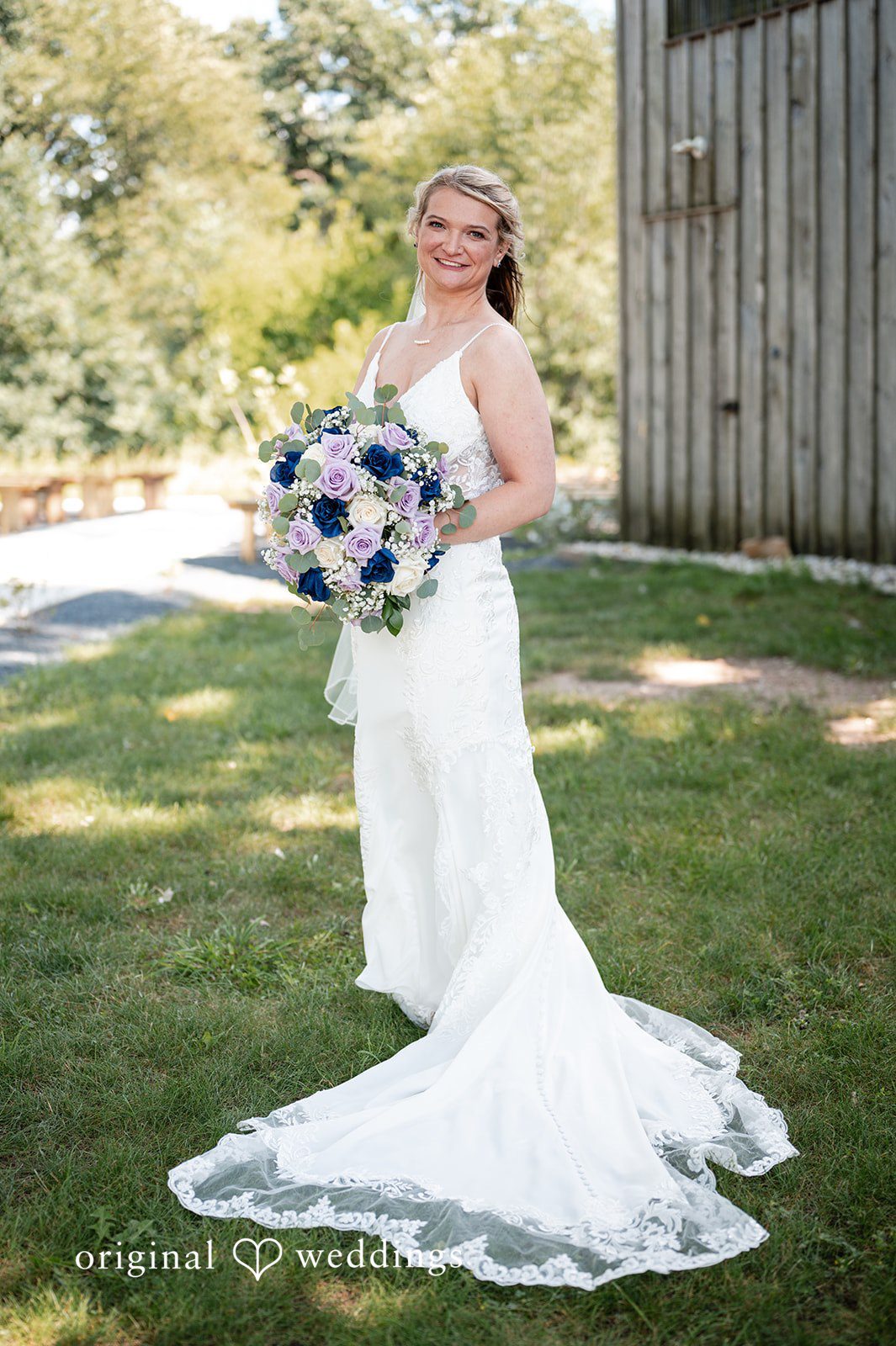 A bride full-length portrait showing off the long train of her gown.