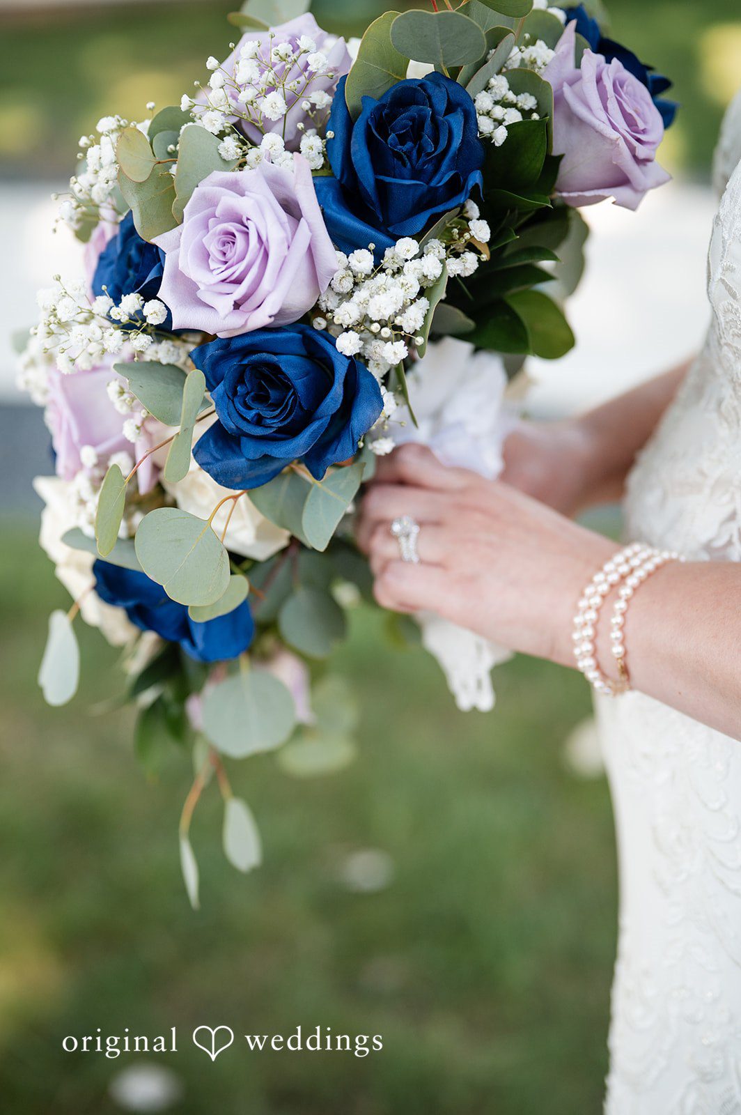 Close-up of a bouquet filled with white and royal blue roses.