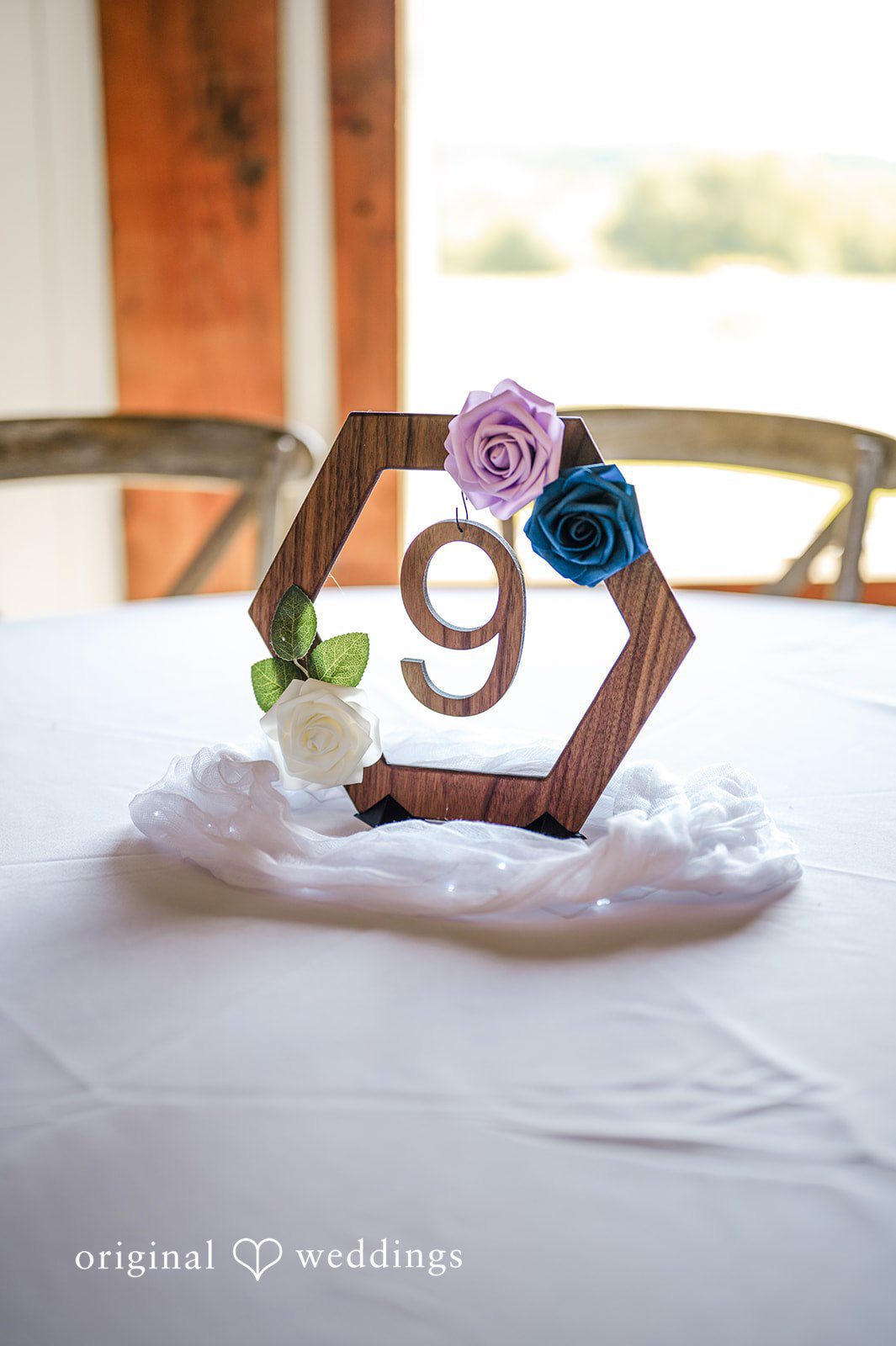 A rustic centerpiece featuring a wooden number nine sign.
