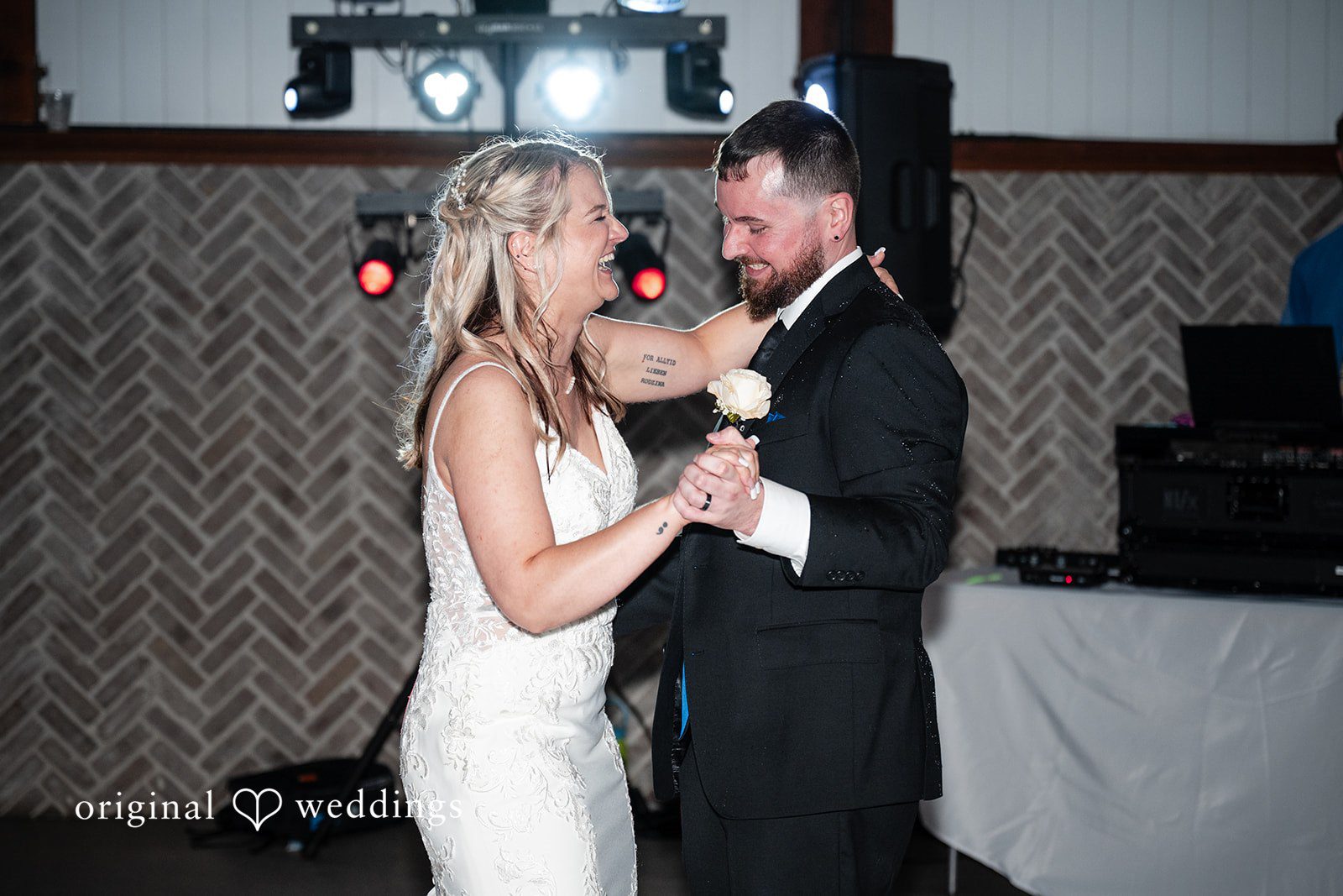 A bride and groom share first dance after ceremony.