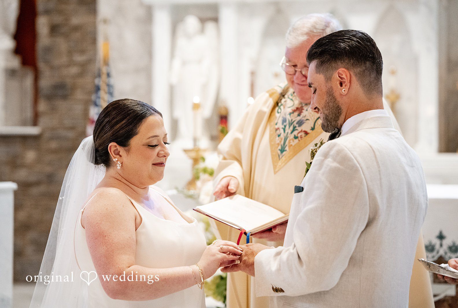 A bride and groom facing each other during their wedding ceremony at Loch Aerie Mansion captured by Philadelphia Wedding Photographers from Original Weddings..