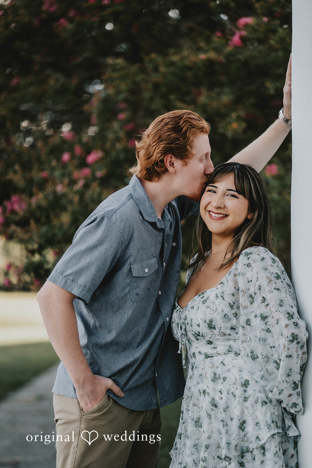 The groom gives his bride a head kiss