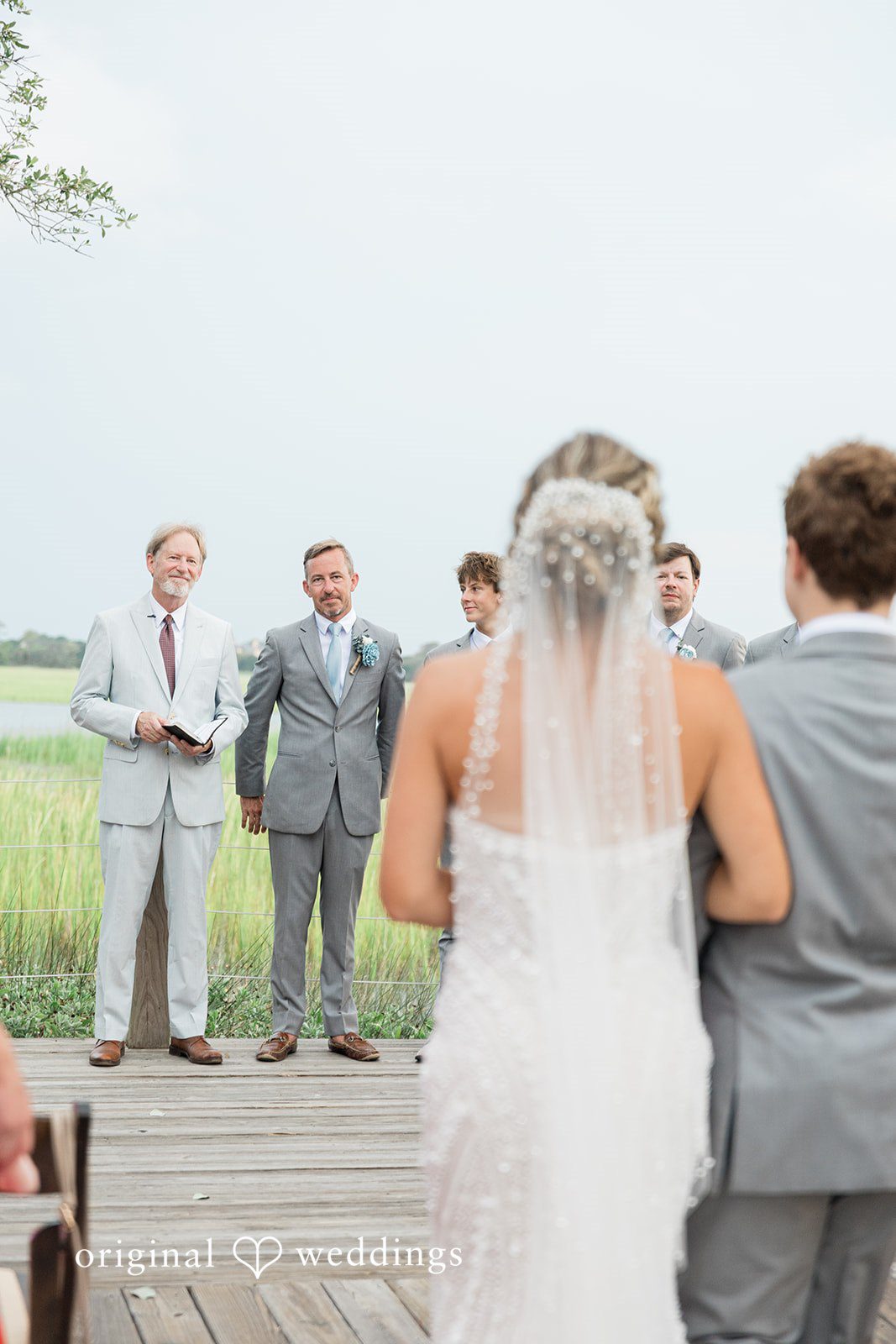 Jennifer + Zac A wedding ceremony with the bride and groom standing at the altar surrounded by their wedding party.