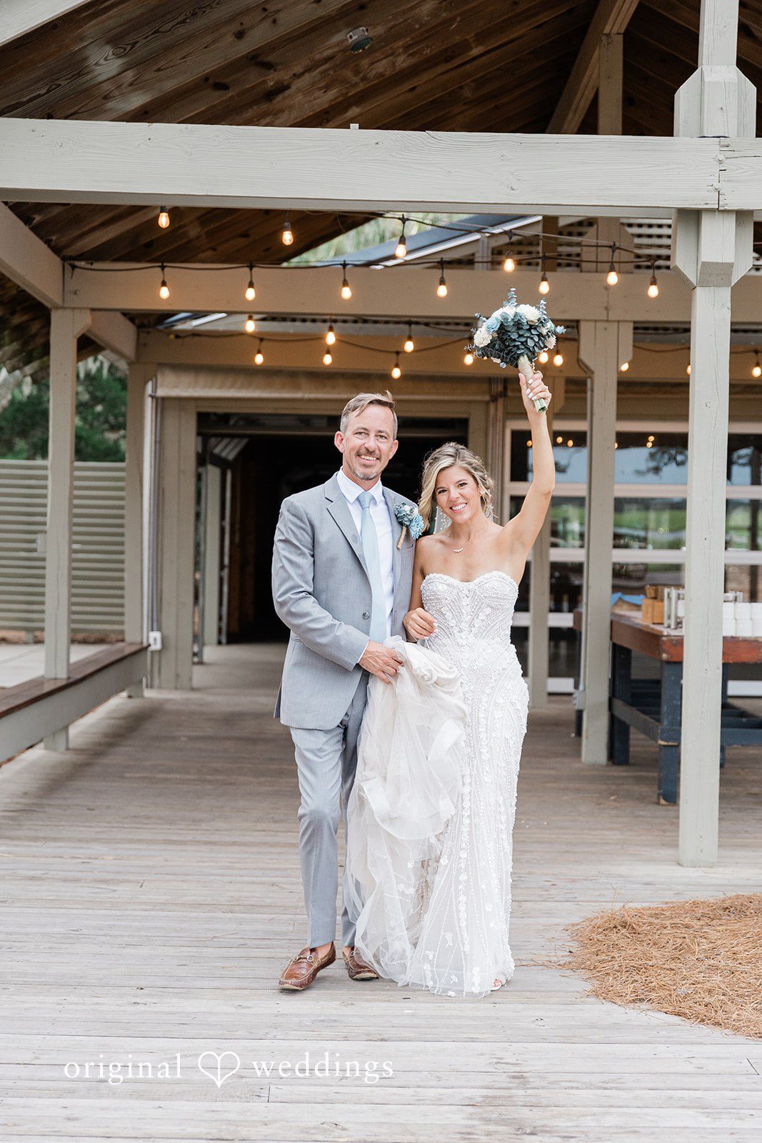 Jennifer + Zac A bride and groom holding hands while walking through a wooden structure.