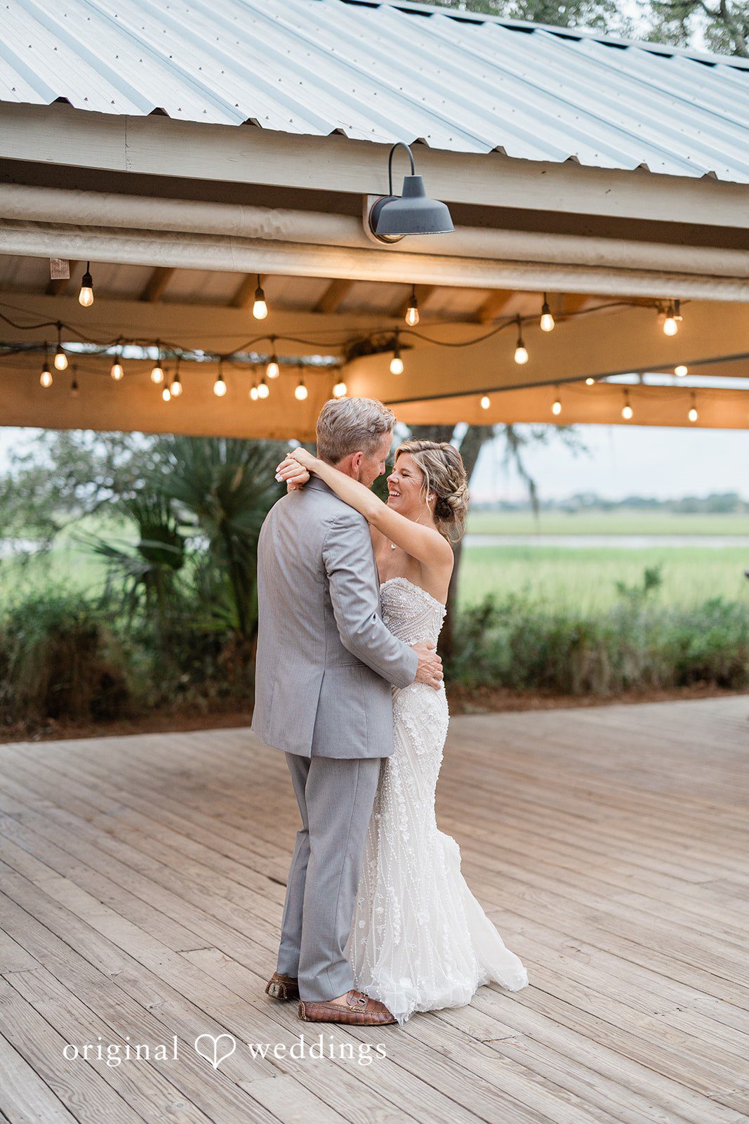 Jennifer + Zac A bride and groom dancing together under an open-air structure.