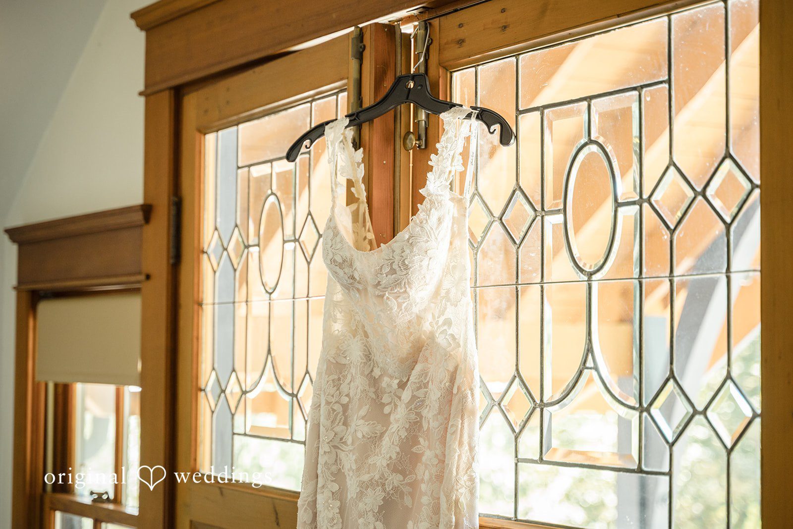 Nikkole + Grant The bride's gown gracefully hanging