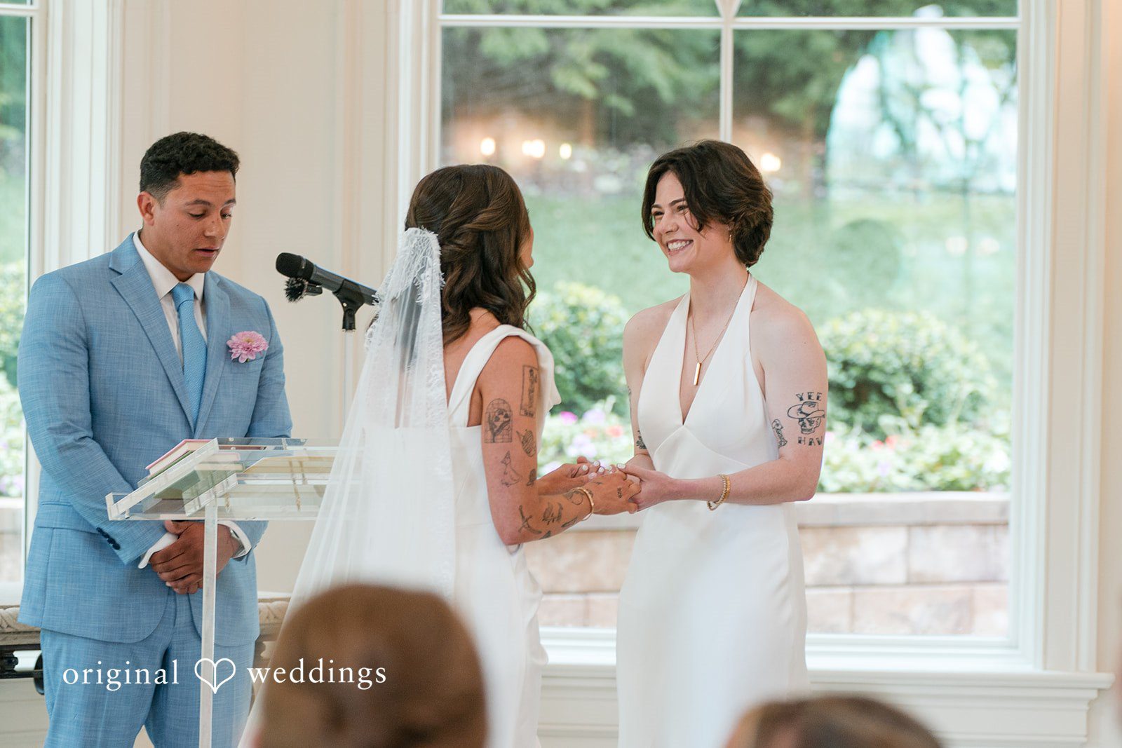 A couple standing at the altar exchanging vows during their wedding ceremony.