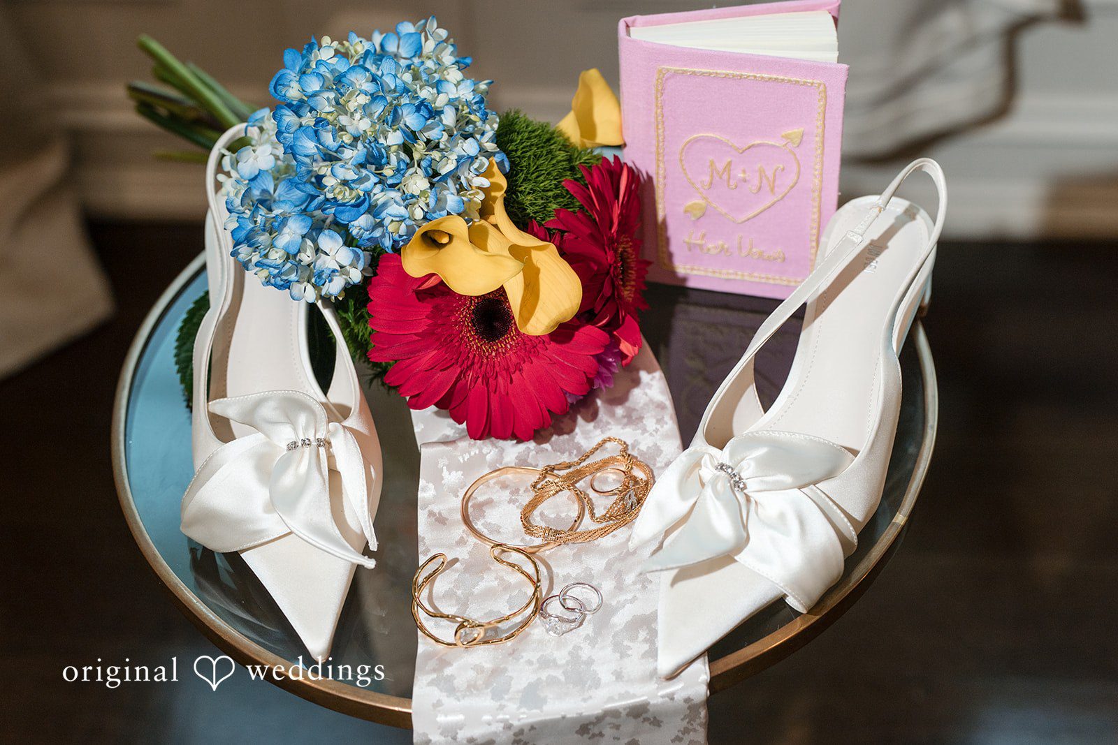 A detailed shot of table decor featuring a floral centerpiece and a decorated plate.
