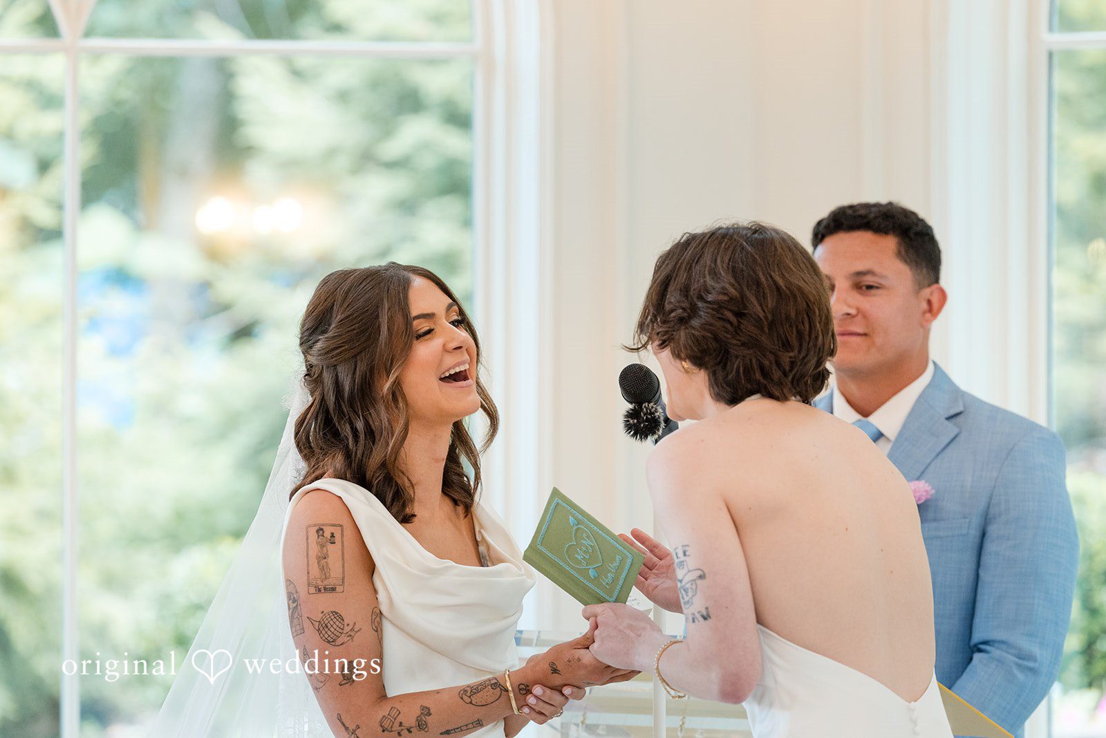 A bride interacting with guests seated at a table during a wedding reception.