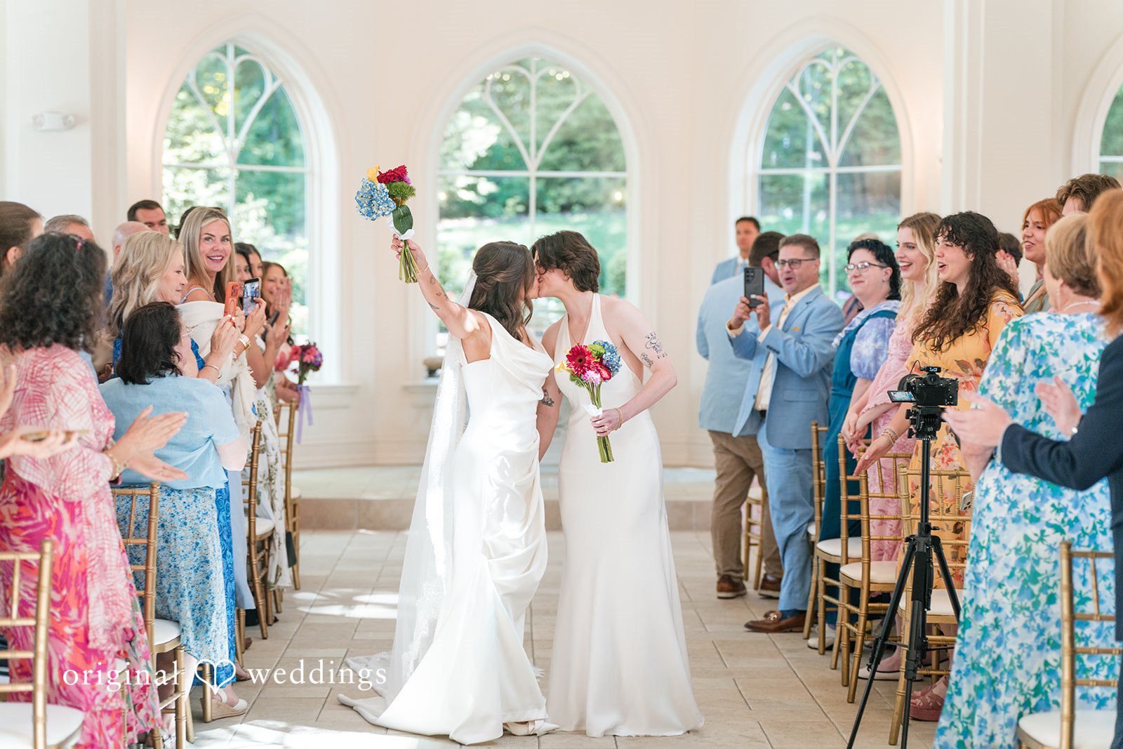 Couple sharing first kiss after wedding ceremony.