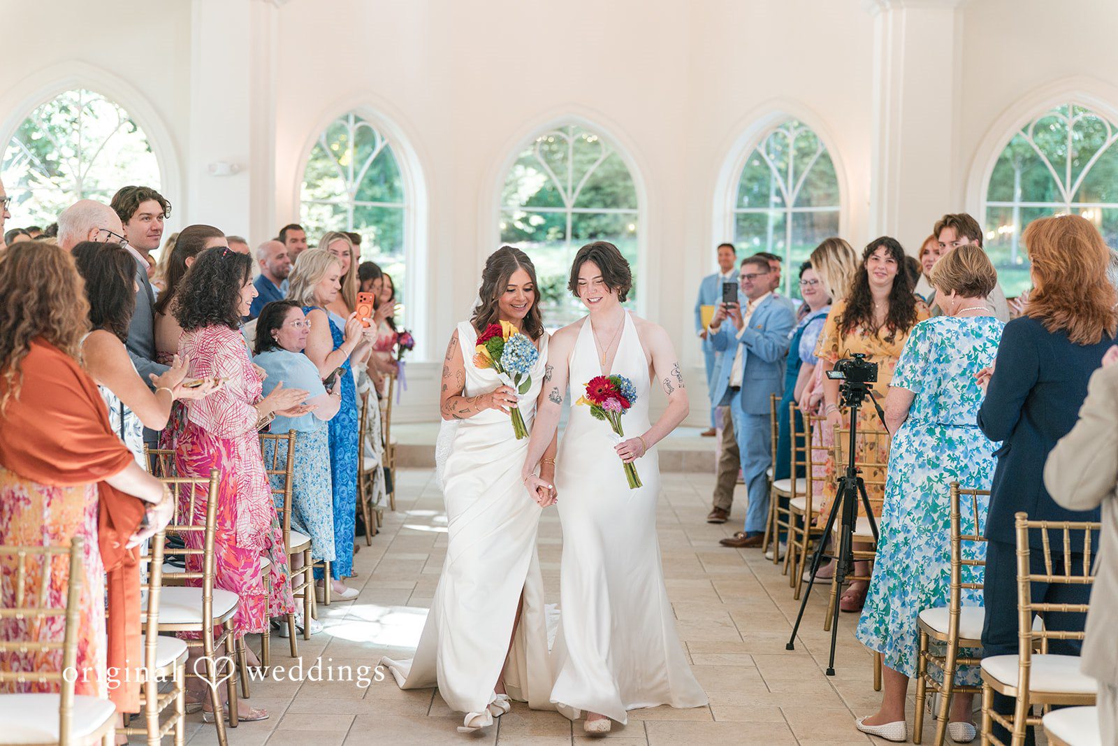 Couple walking down an aisle after wedding ceremony.