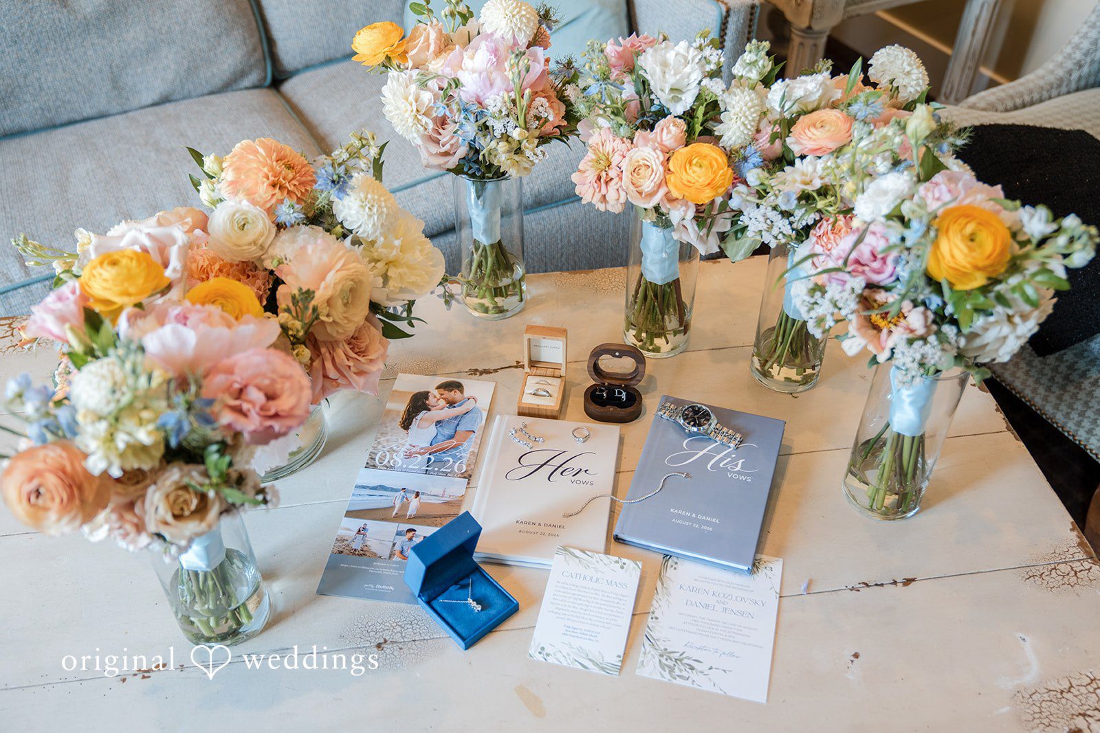 Daniel + Karen A colorful floral arrangement decorating an elevated reception or welcome table.
