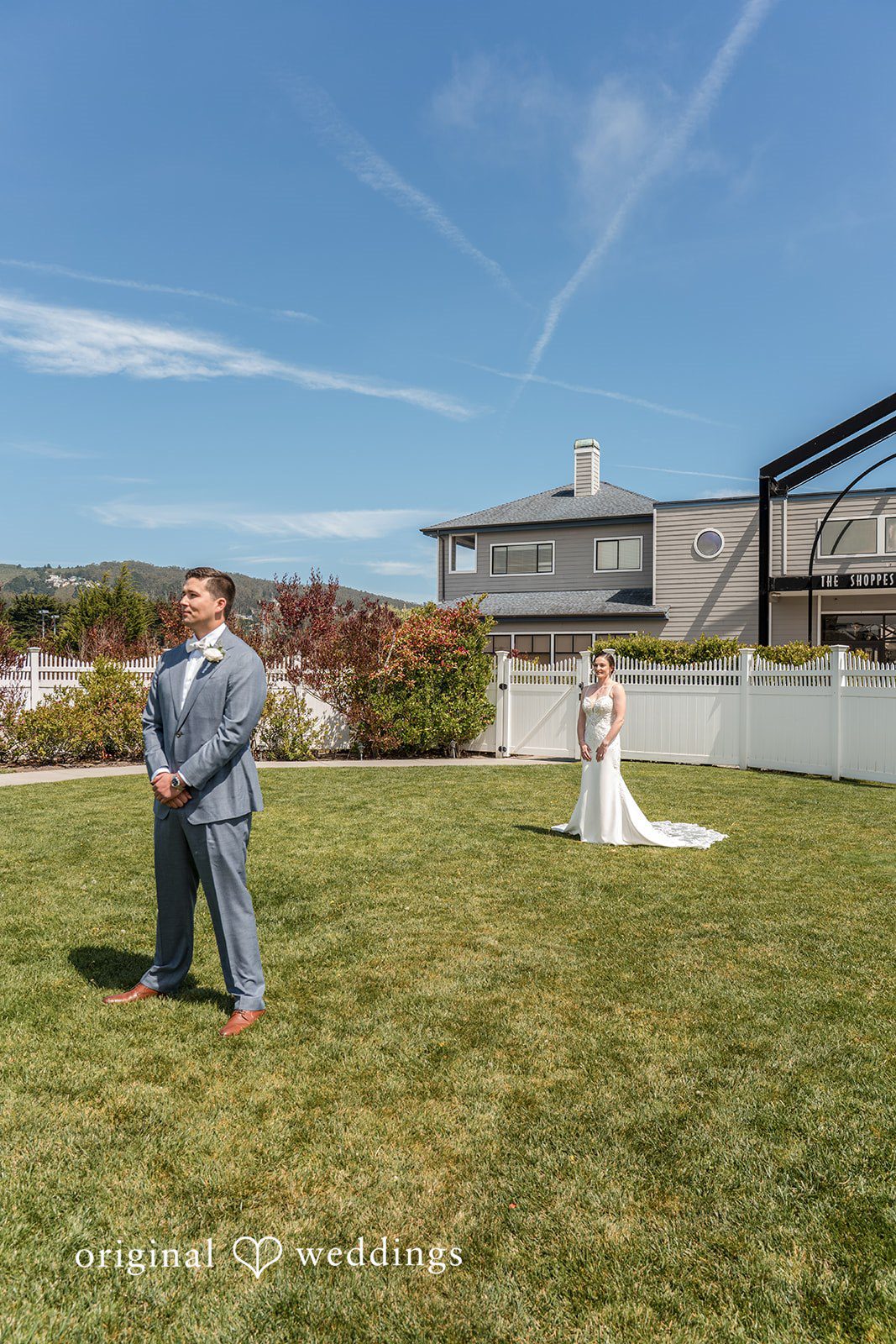 Daniel + Karen A bride in a long train wedding dress walking across a green lawn.
