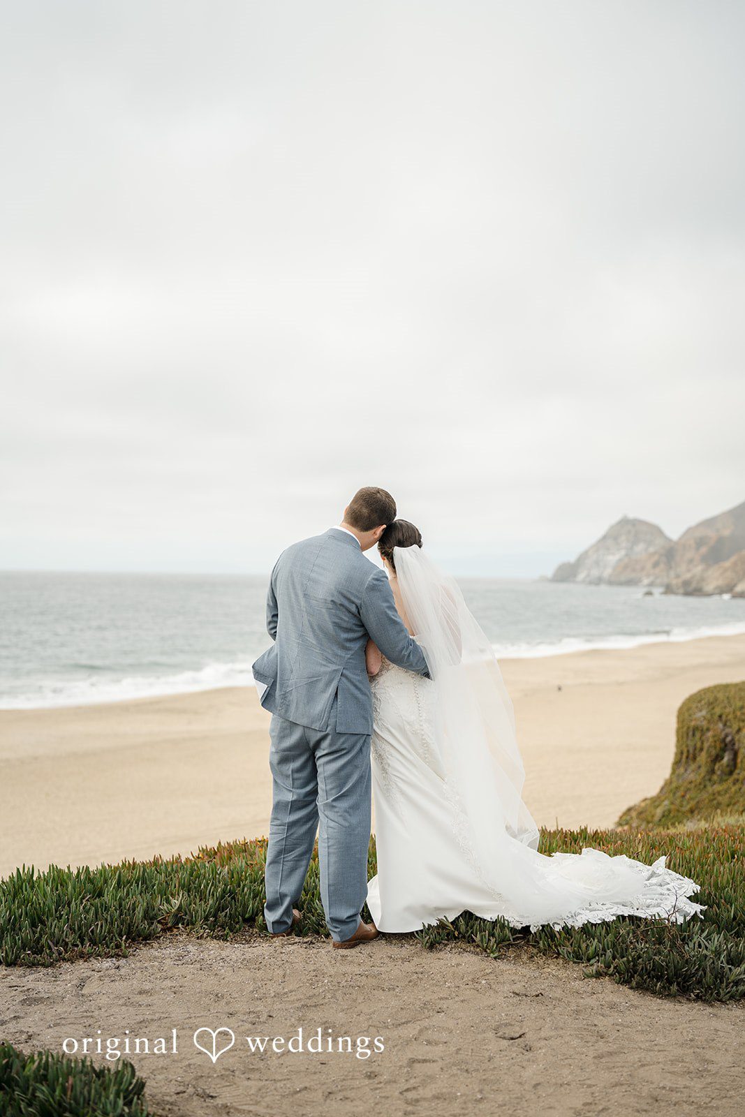 Daniel + Karen A groom dipping his bride for a romantic moment on a sandy beach.