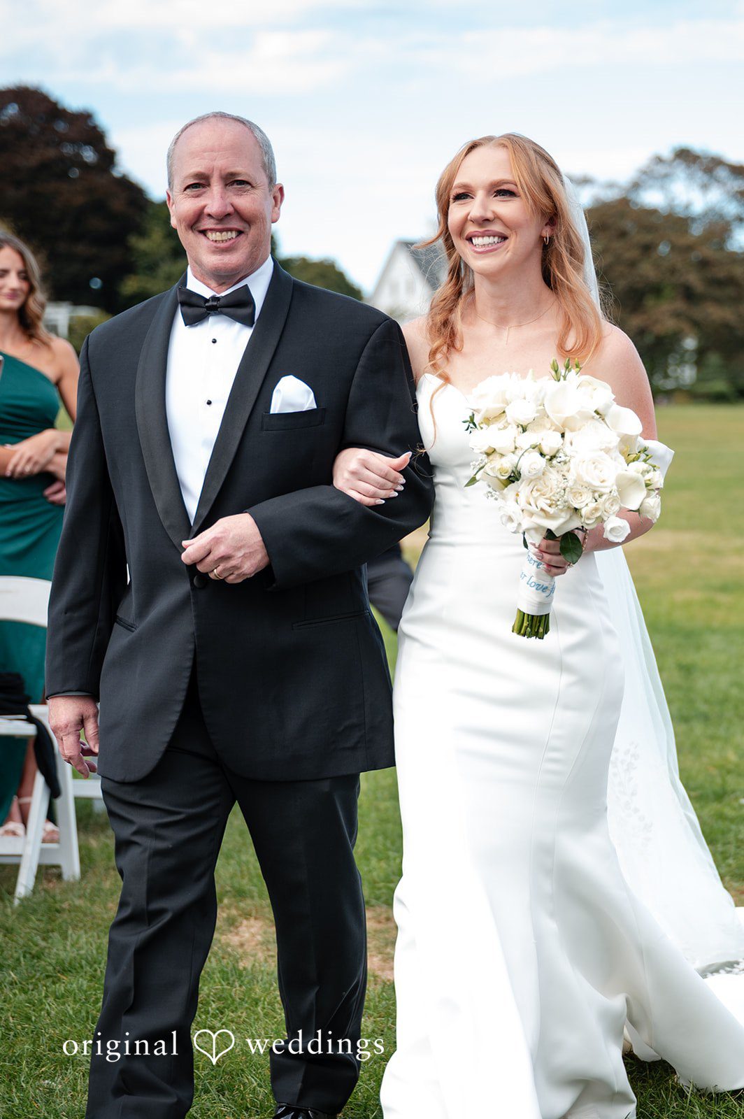 The bride's father escorts the bride down the aisle