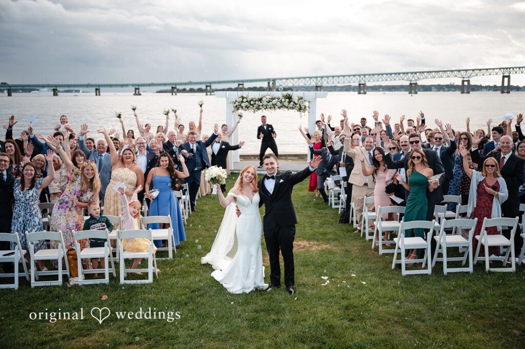 Our Providence wedding photographers at Original Weddings captured a joyful portrait of the couple and their wedding party at the Officer's Club