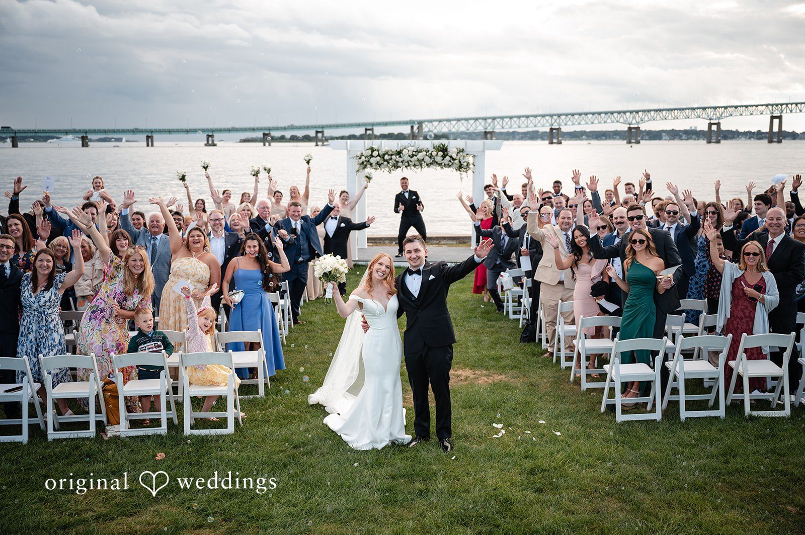 Our Providence wedding photographers at Original Weddings captured a joyful portrait of the couple and their wedding party at the Officer's Club