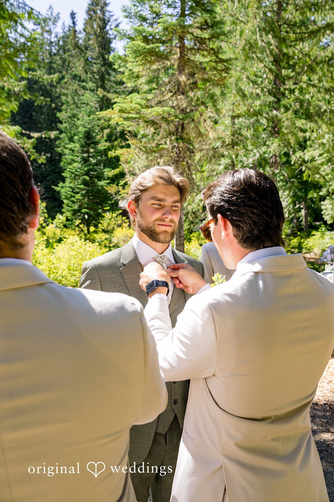 Abigail + Reece A groom receiving assistance from his groomsmen while getting ready.