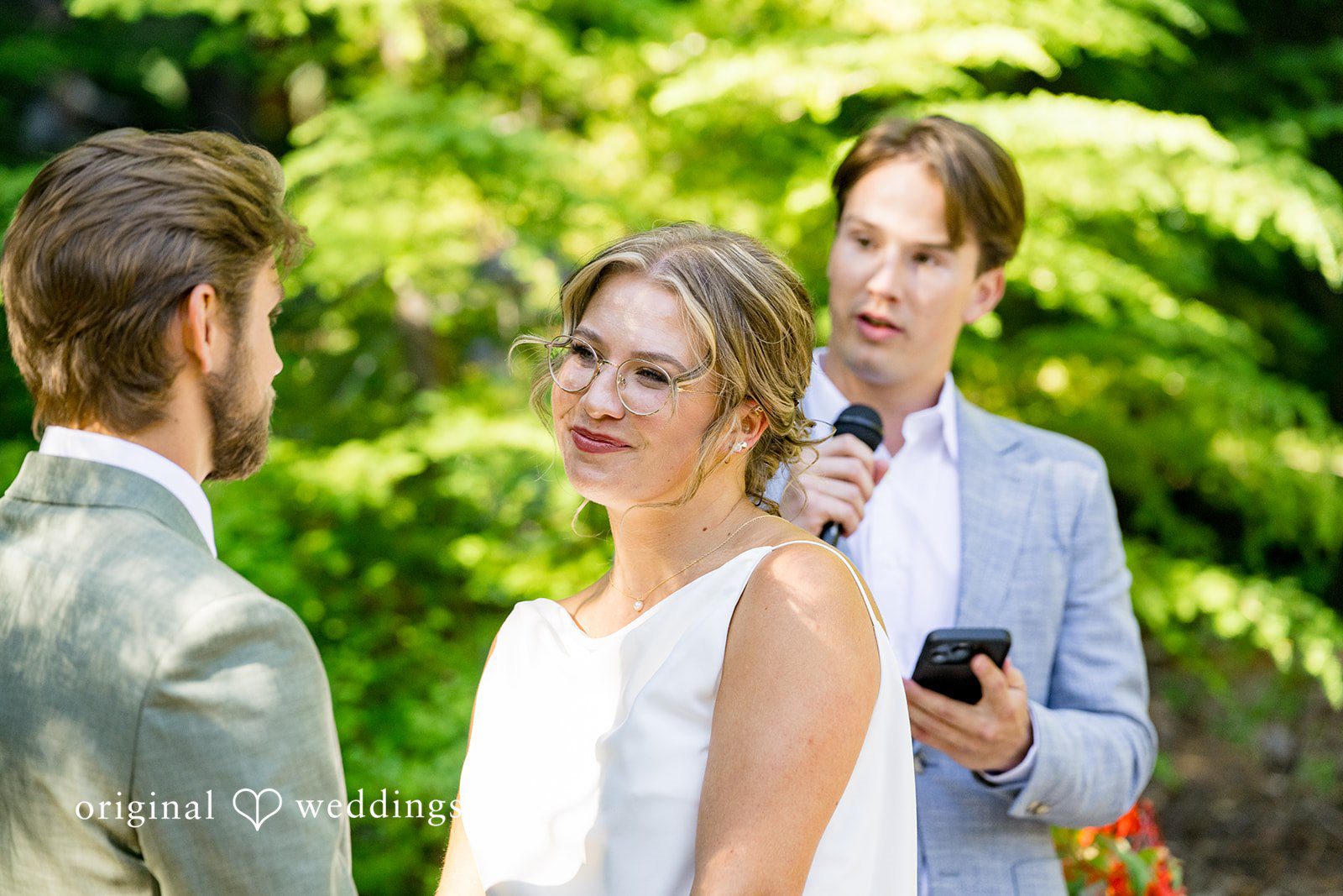 Abigail + Reece A bride looking over her shoulder toward the officiant during a ceremony.