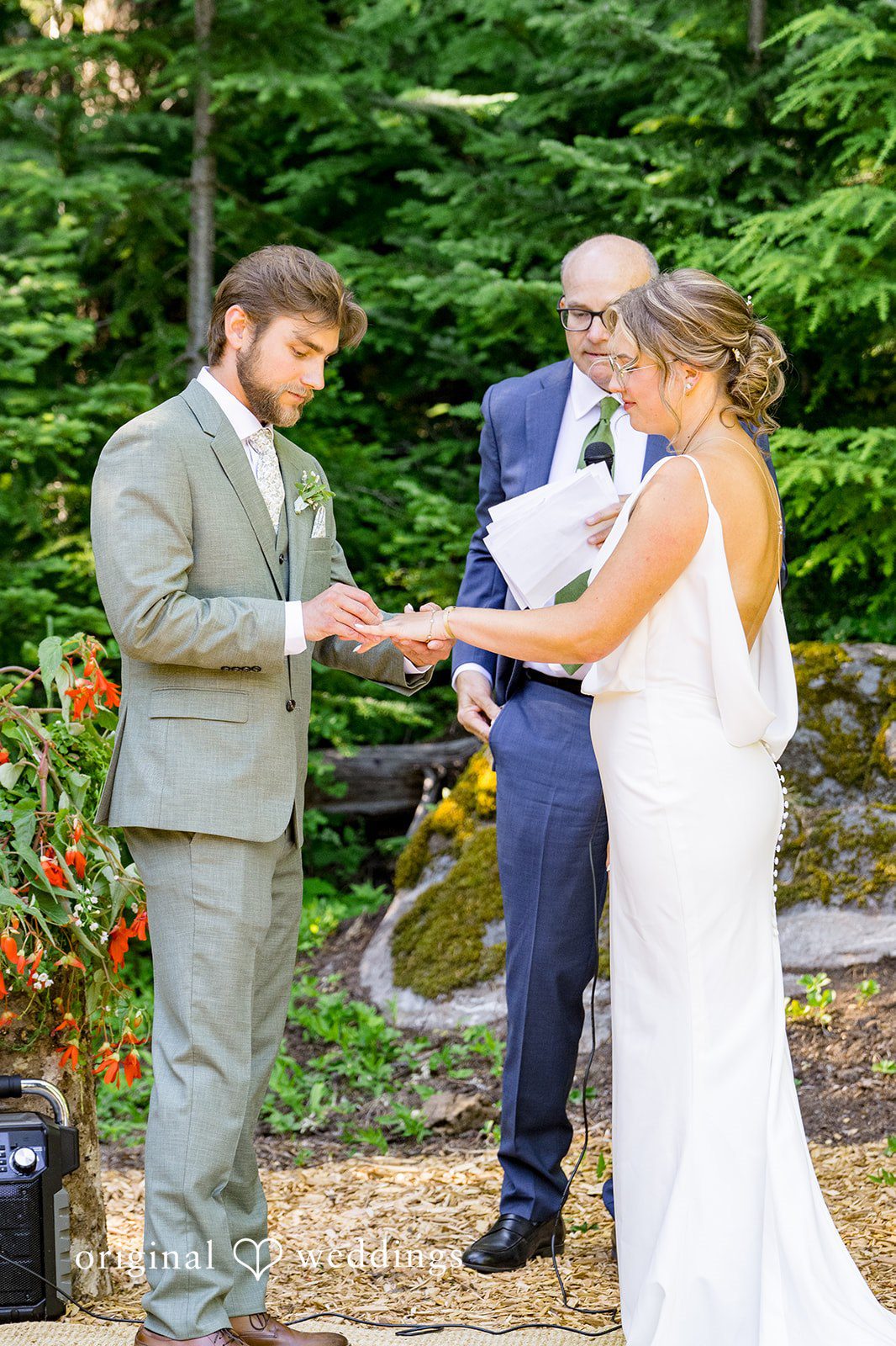 Abigail + Reece A groom placing a ring on the bride's finger during the ceremony.