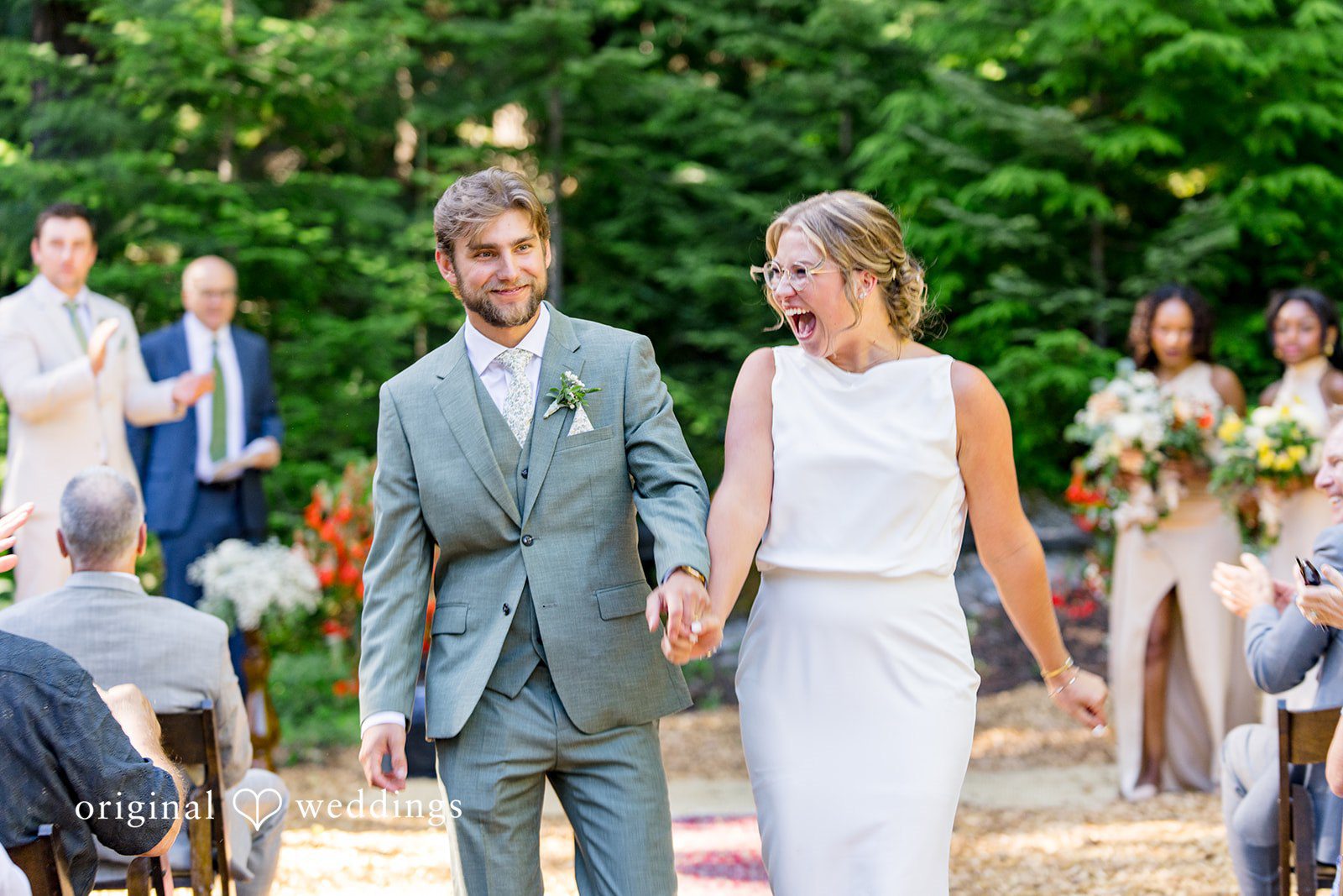Abigail + Reece A newly married husband and wife walking down the aisle together.