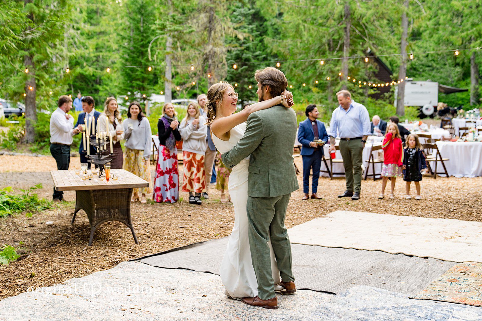 Abigail + Reece A bride and groom sharing a dance surrounded by wedding guests.