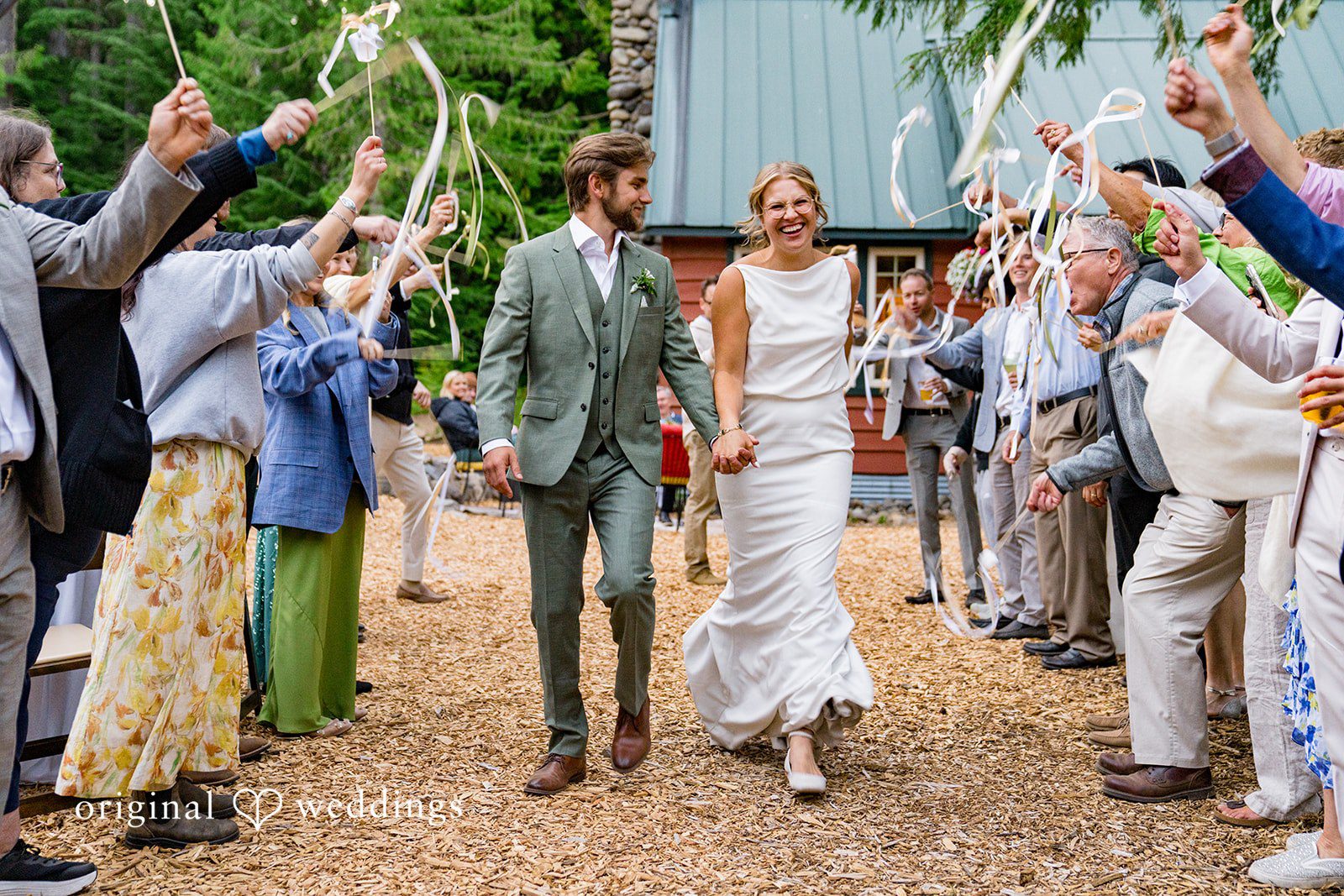 Abigail + Reece Newlyweds walking through cheering guests tossing confetti.