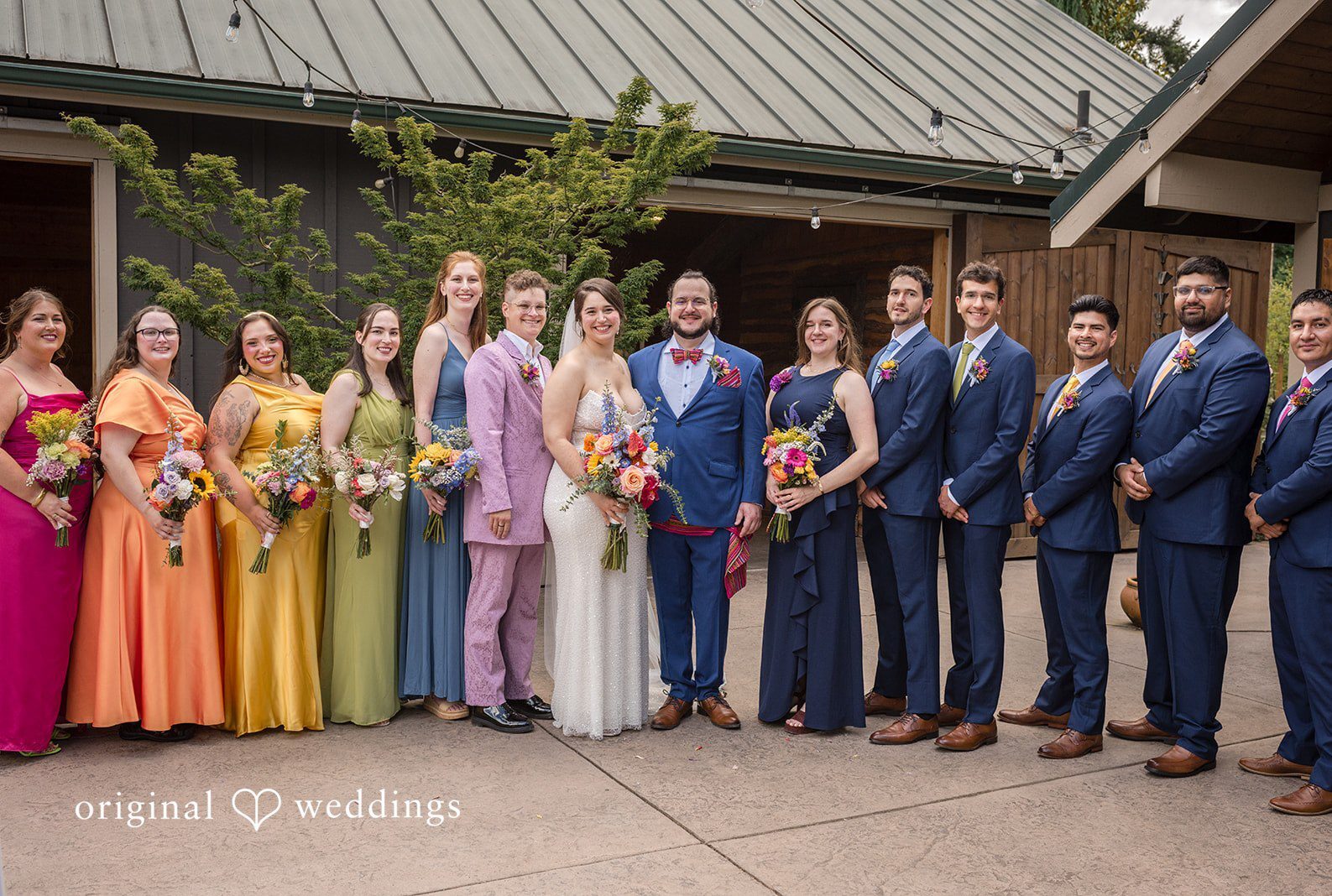 A full wedding party posing together at Pine Creek Nursery by Seattle Wedding Photographers from Original Weddings.