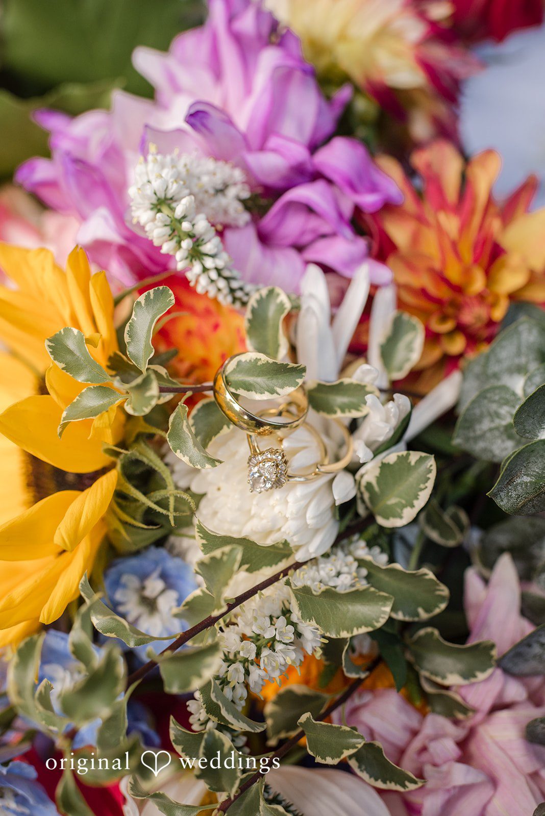 Diego + Adel A dense bouquet featuring a mix of bright yellow, orange, and purple flowers.