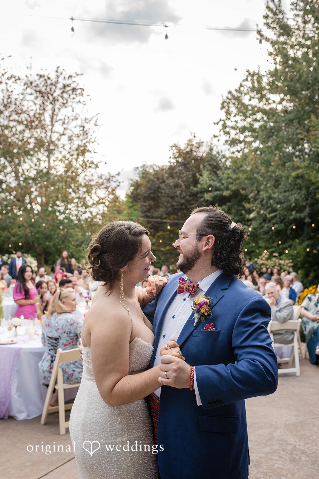 Diego + Adel A bride and groom sharing their first dance together on a dance floor.