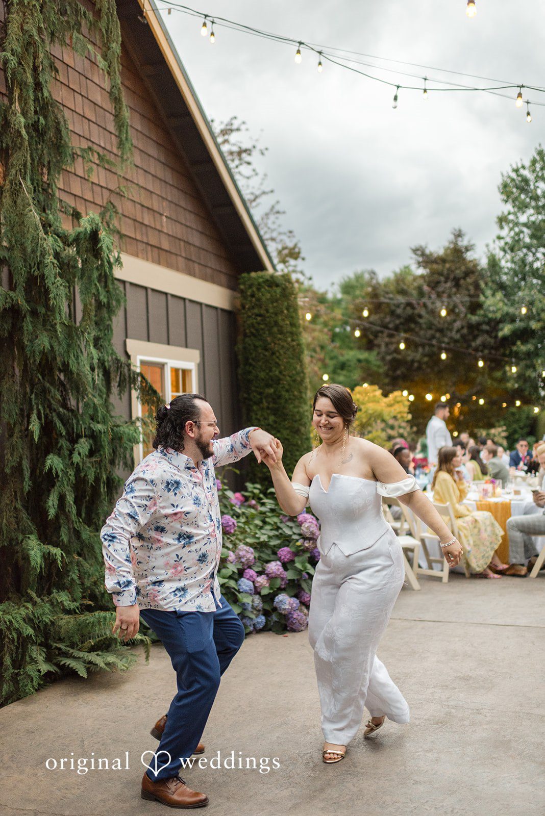 Diego + Adel A bride and groom joyfully dancing together during their outdoor wedding reception.
