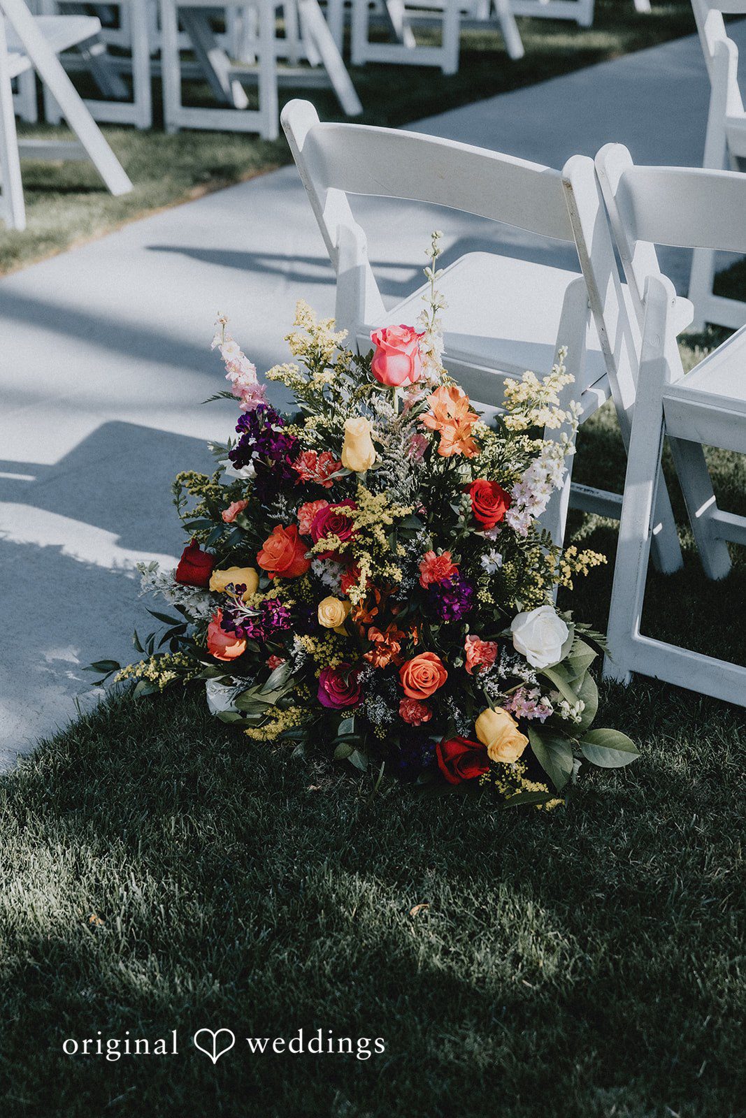 A vibrant and colorful floral arrangement arranged on the ground.