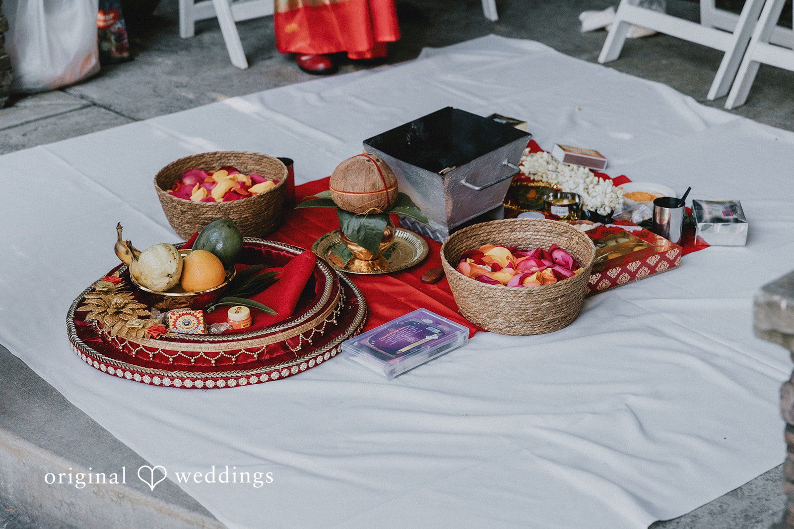 Decorative gold platters and ceremonial items arranged on a white surface.