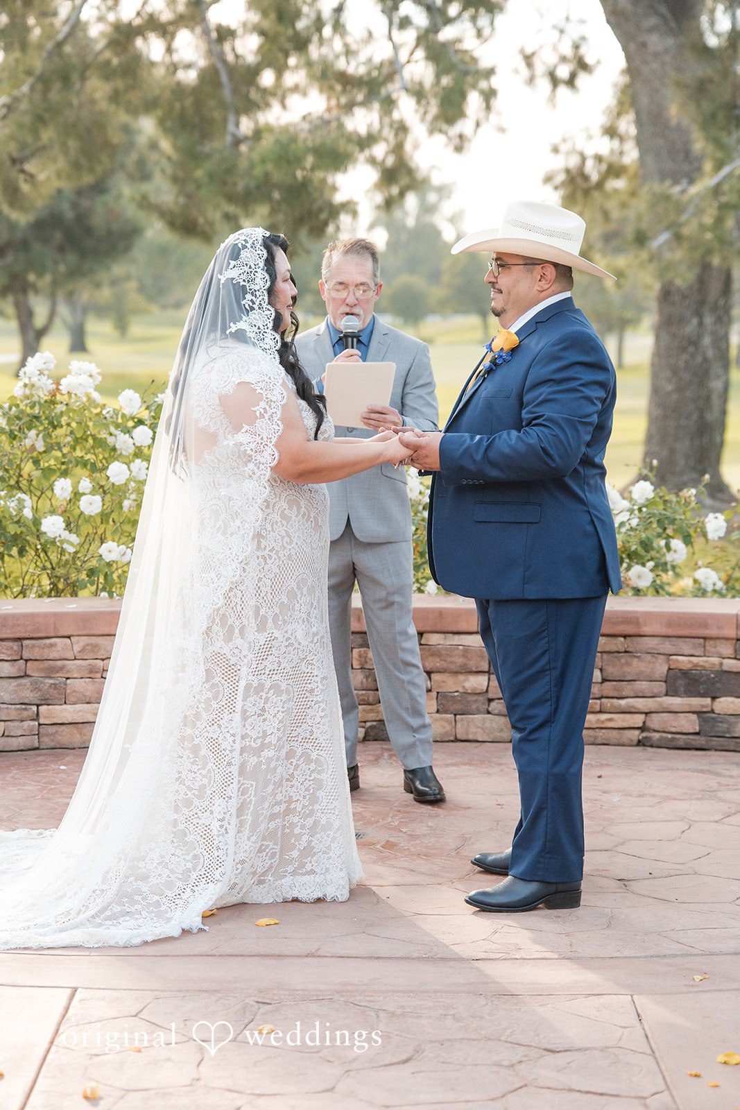 A bride and groom standing together during their wedding ceremony.