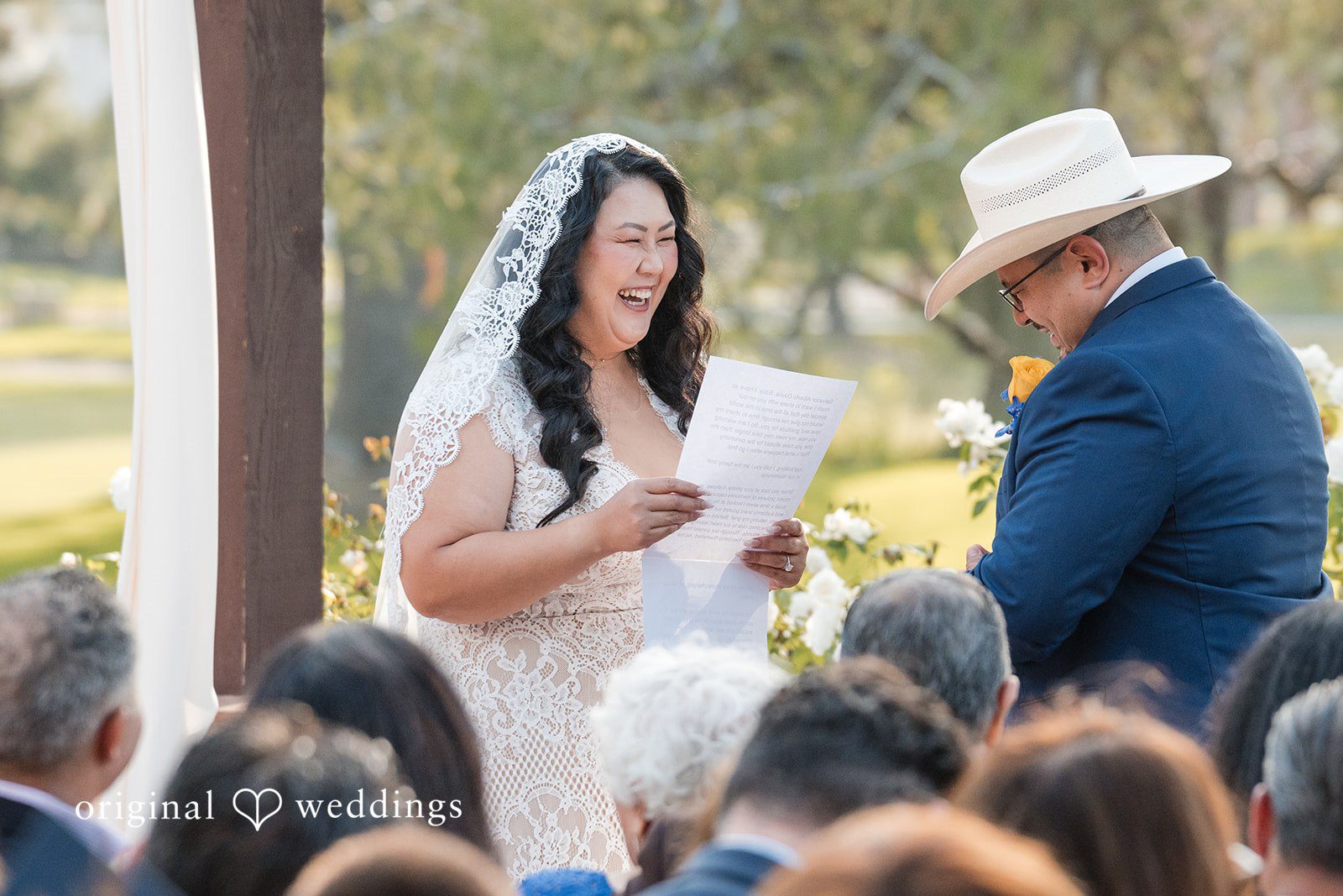 A bride reading her vows to the groom at the altar.