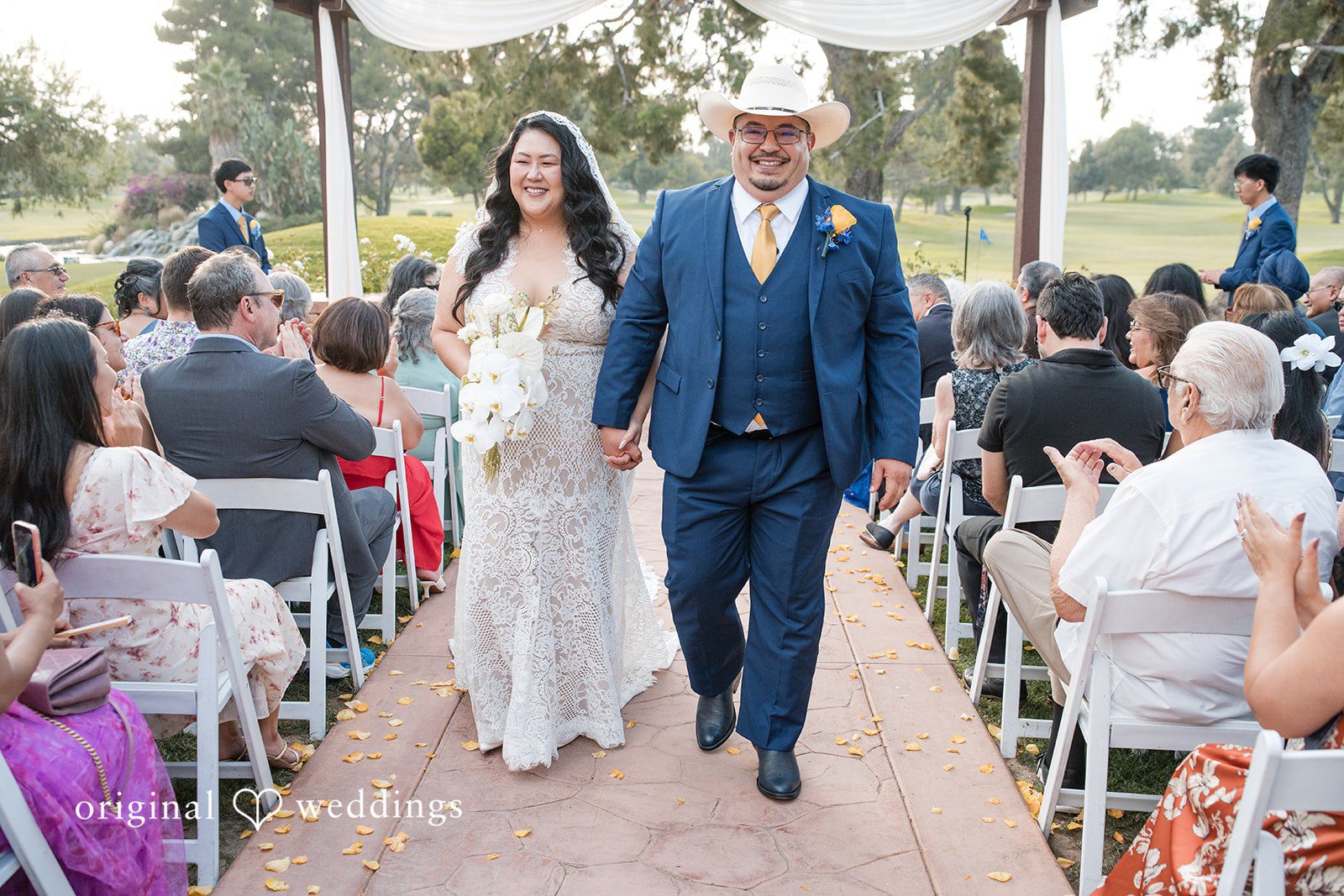 A newly married couple walking down the aisle after the ceremony.