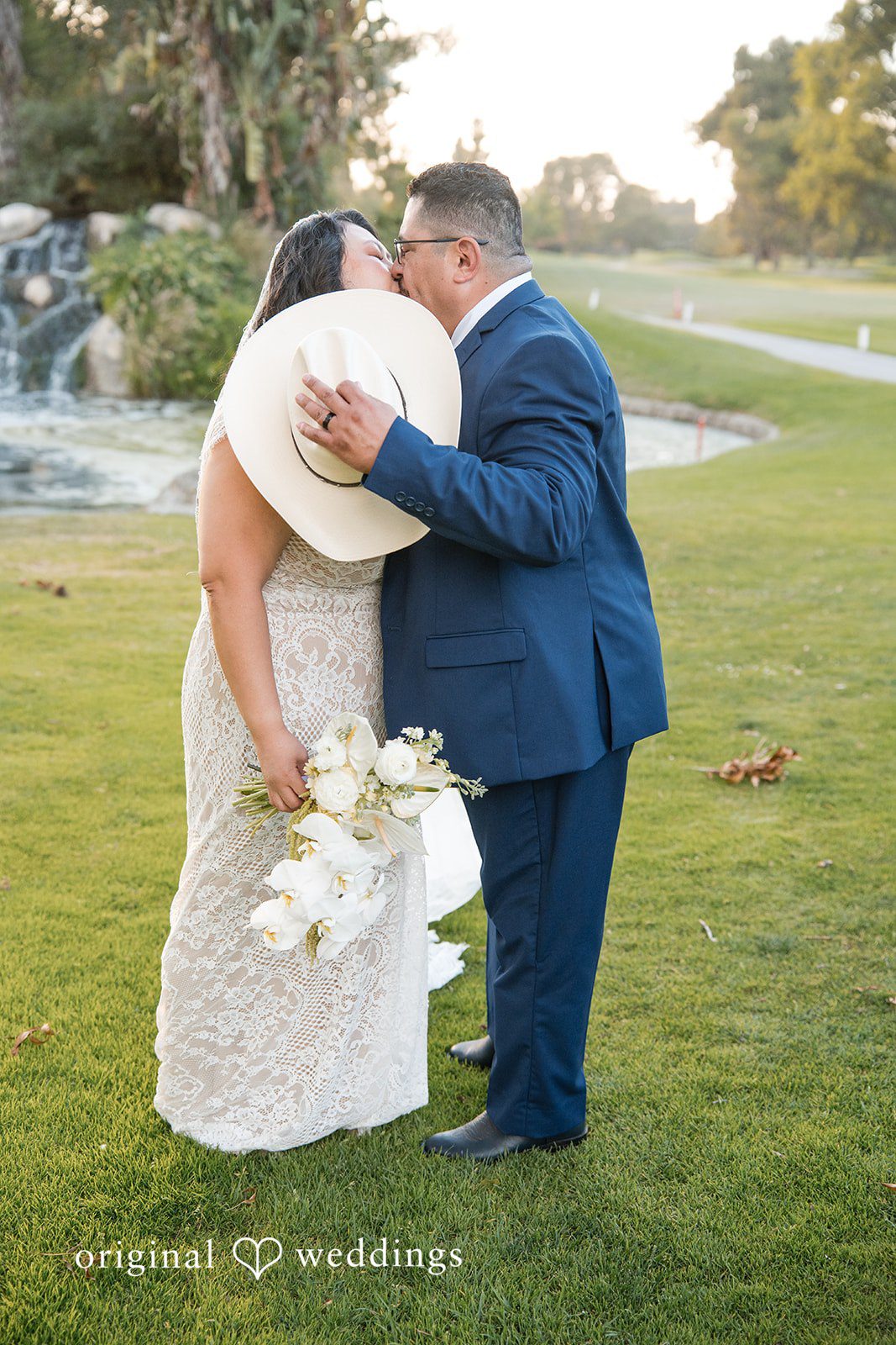 A groom dipping his bride for a romantic kiss.