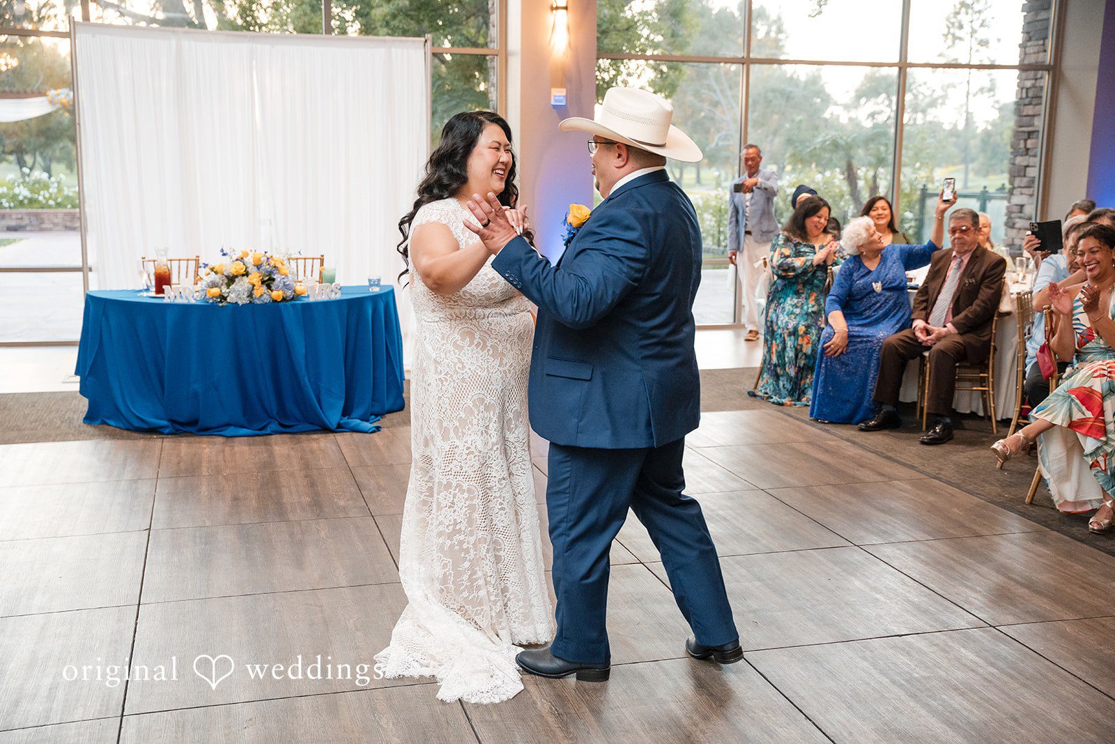 A bride and groom dancing together on the dance floor during their reception.