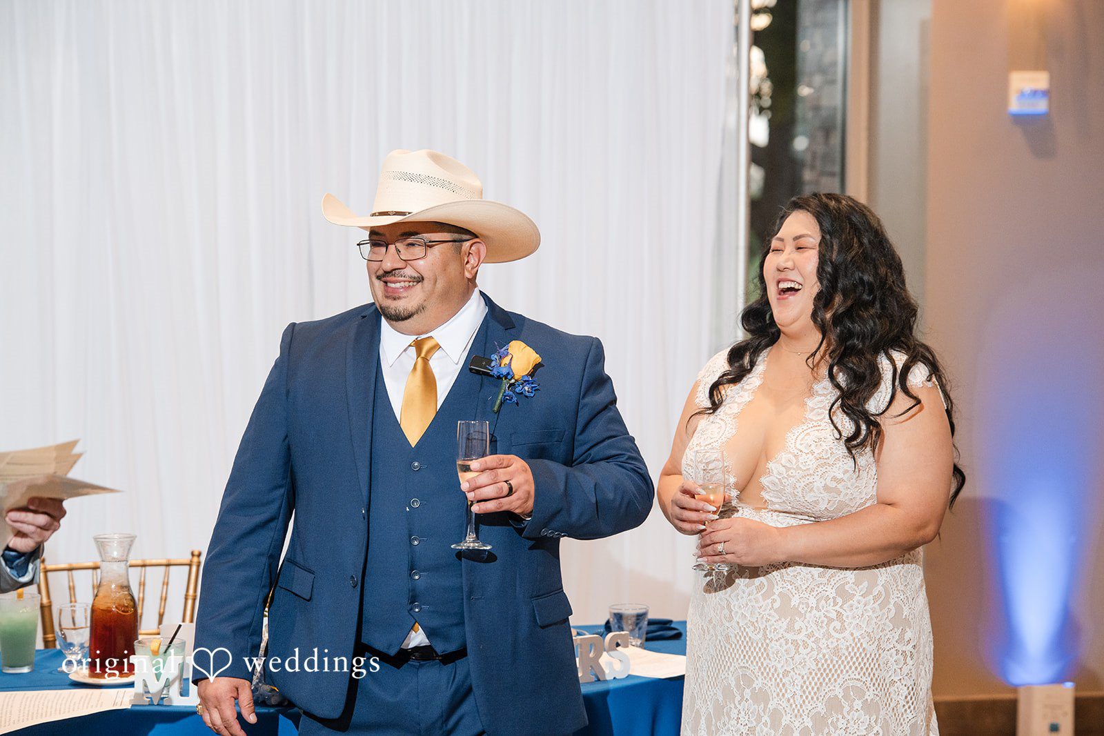 A bride and groom standing together during a reception event.