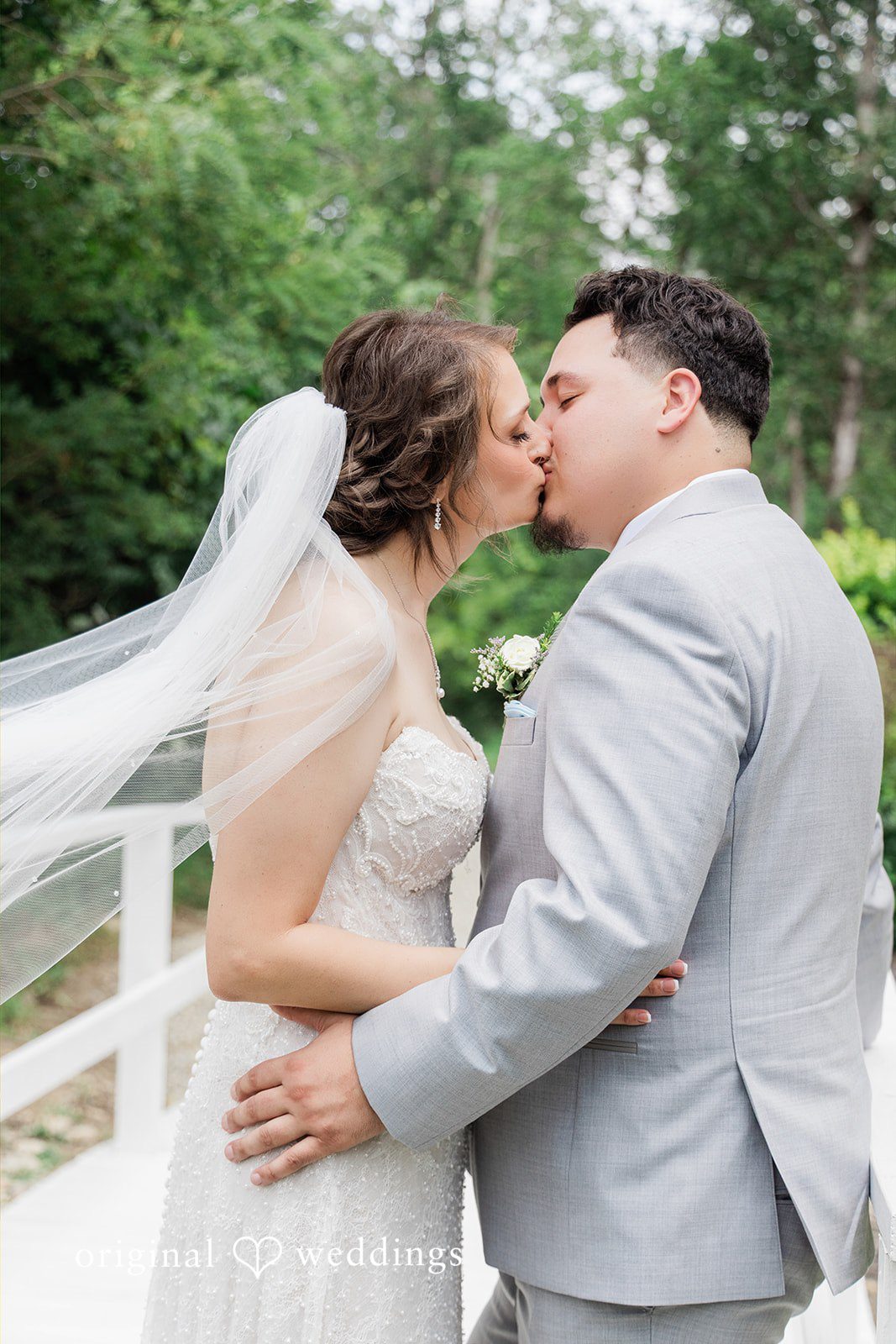 Alexander + Annalisse A groom holds his bride close as they share an intimate embrace against a soft background.