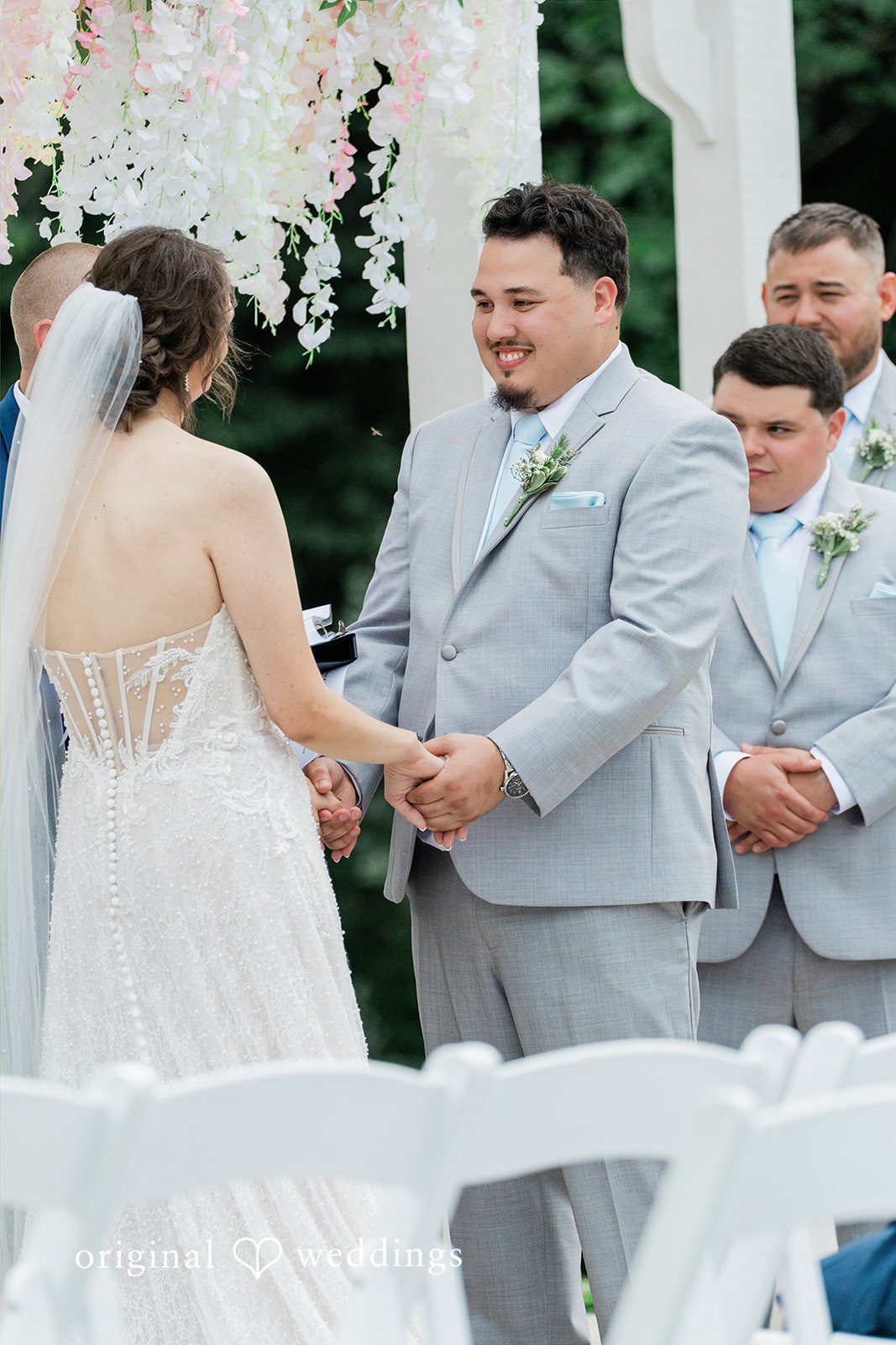 Alexander + Annalisse The newlyweds stand together while chatting with members of their wedding party.
