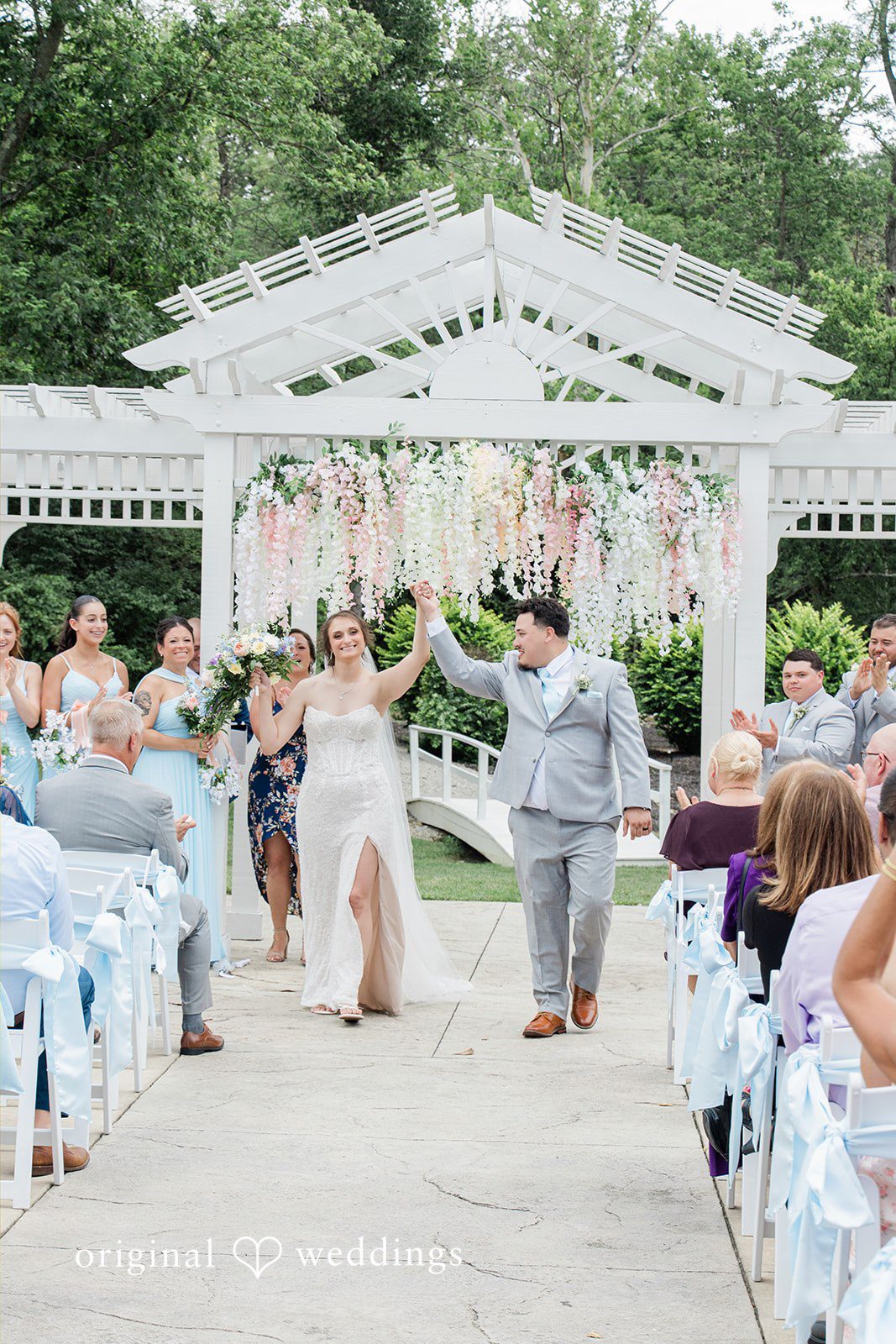Alexander + Annalisse Bride and groom walking down an aisle after wedding ceremony.