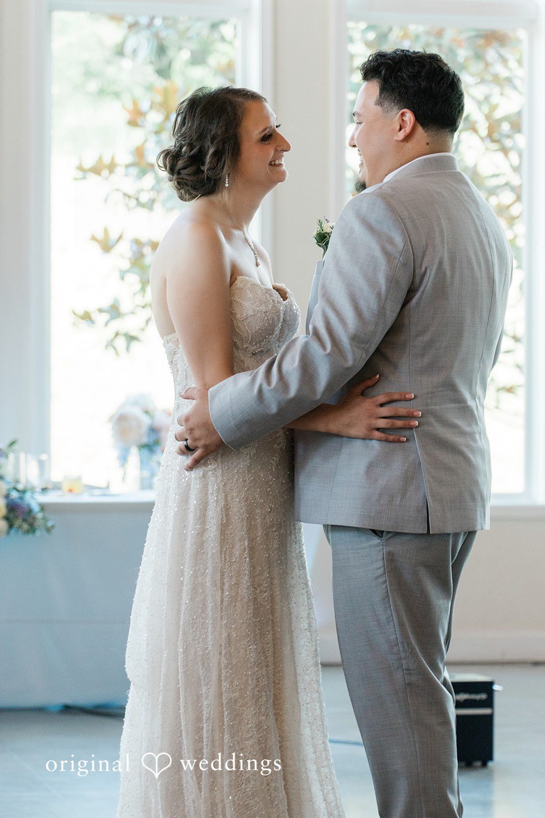 Alexander + Annalisse A groom in a grey suit dances with his bride during their reception.