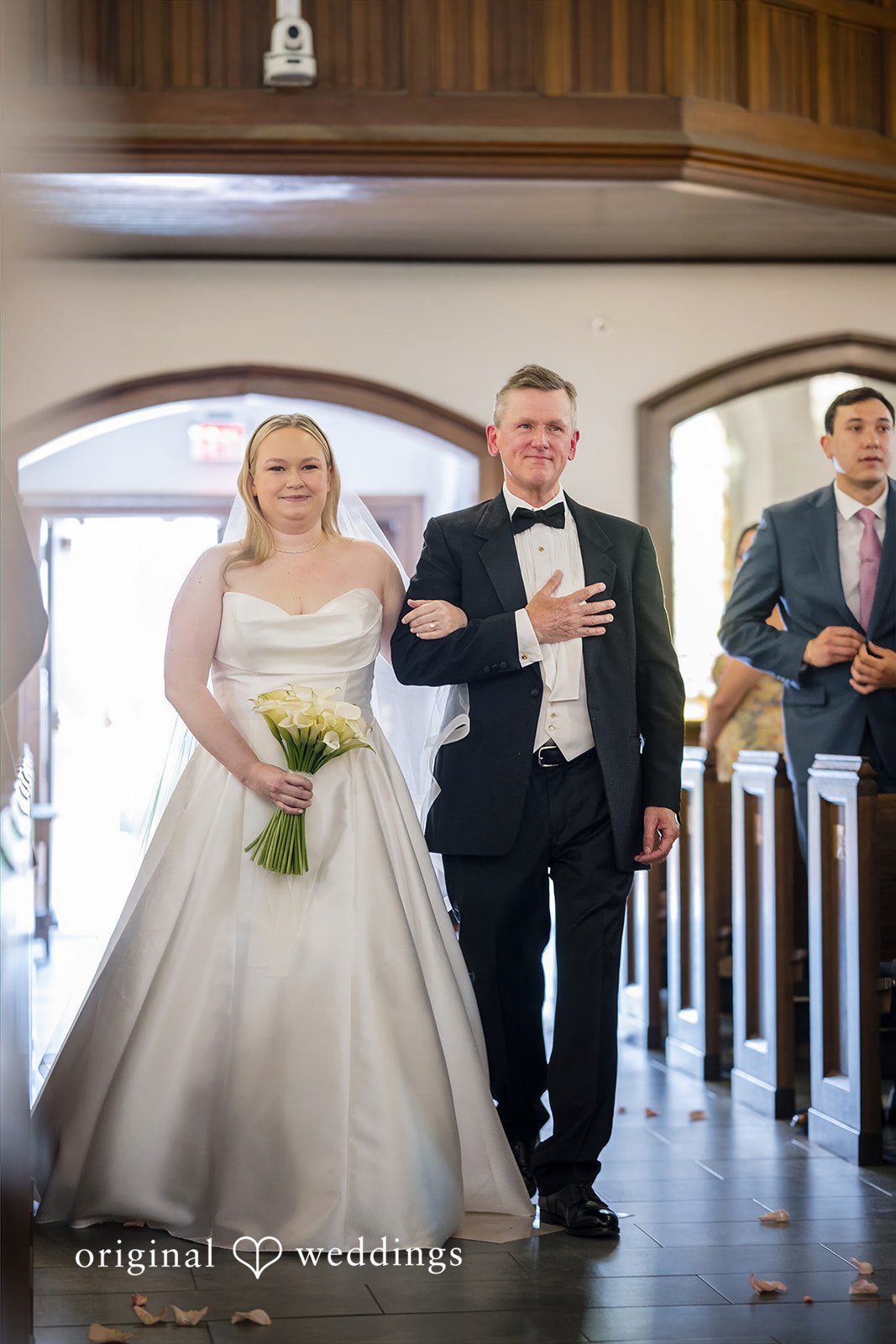 Nicole + Matt A bride and groom walking down the church aisle together after their ceremony.
